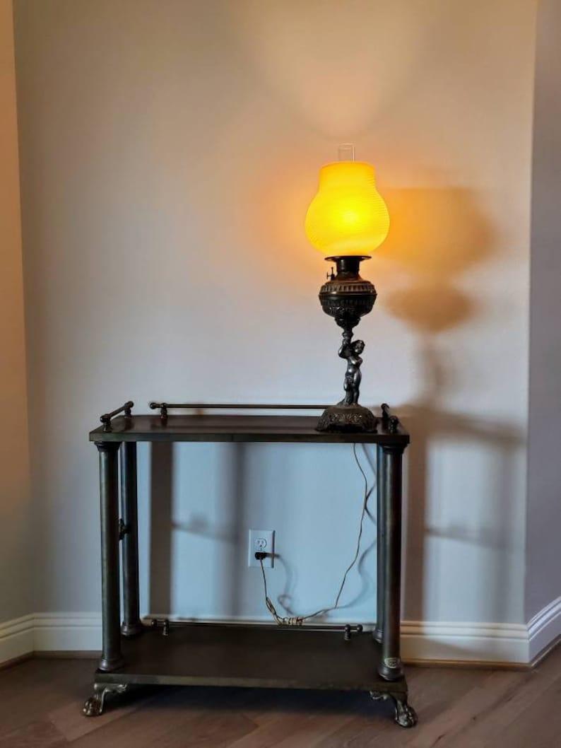 A magnificent American Victorian gilt metal banquet lamp, professionally converted from kerosene oil lamp, now electrified. Elegantly regal, with superb attention to detail, beautifully aged patina, producing a soft, warm ambiance

Born at the