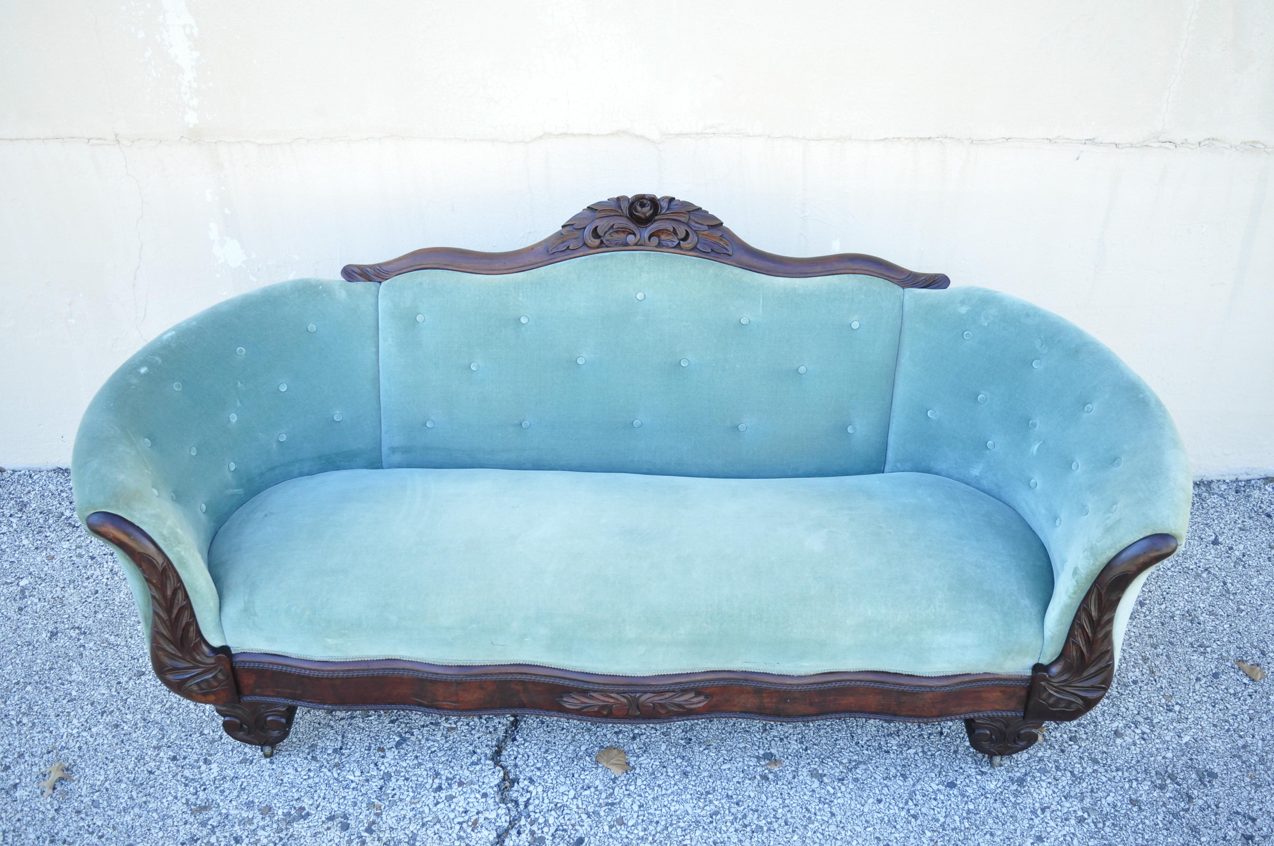 Antique American Victorian Empire crotch Mahogany green mohair serpentine sofa. Item features crotch mahogany serpentine frame, rolling casters, original green mohair upholstery, nicely carved frame, quality American craftsmanship, very nice antique