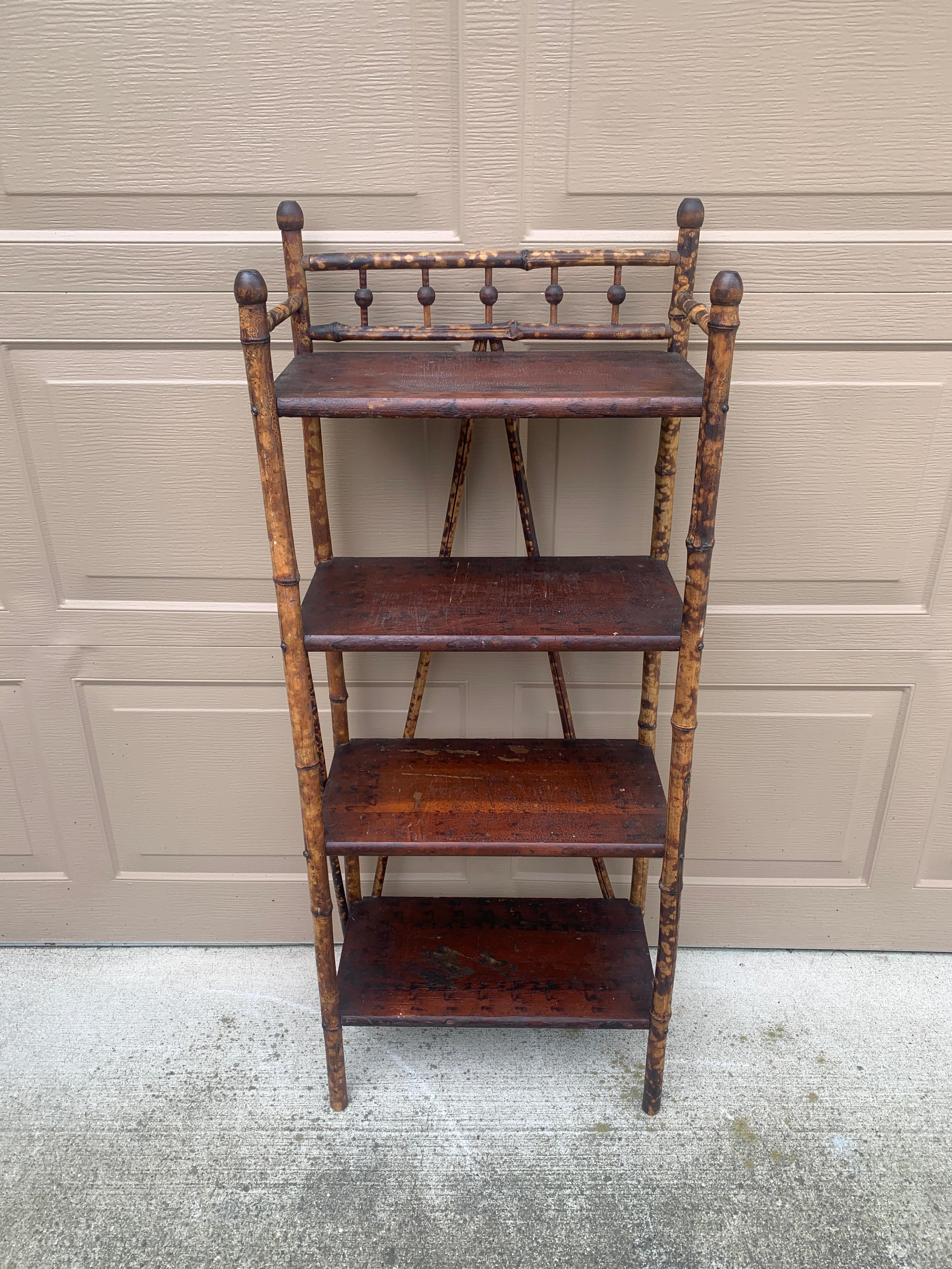 A gorgeous Victorian or British Colonial style wood and faux bamboo four shelf etagere or bookshelf 

USA, Circa 1920s

Measures: 19