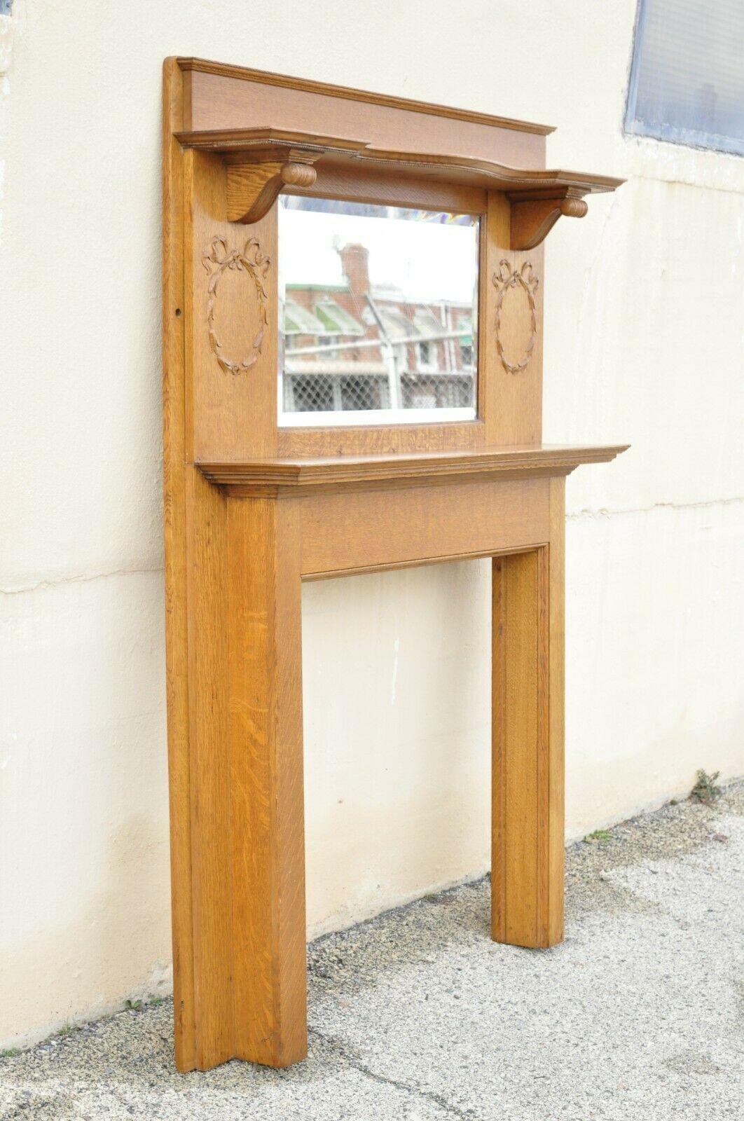 Antique American Victorian golden oak wood fireplace mantel with beveled mirror. Item features beautiful wood grain, nicely carved details, very nice antique item, quality American craftmanship, great style and form. Circa Early 1900s.
