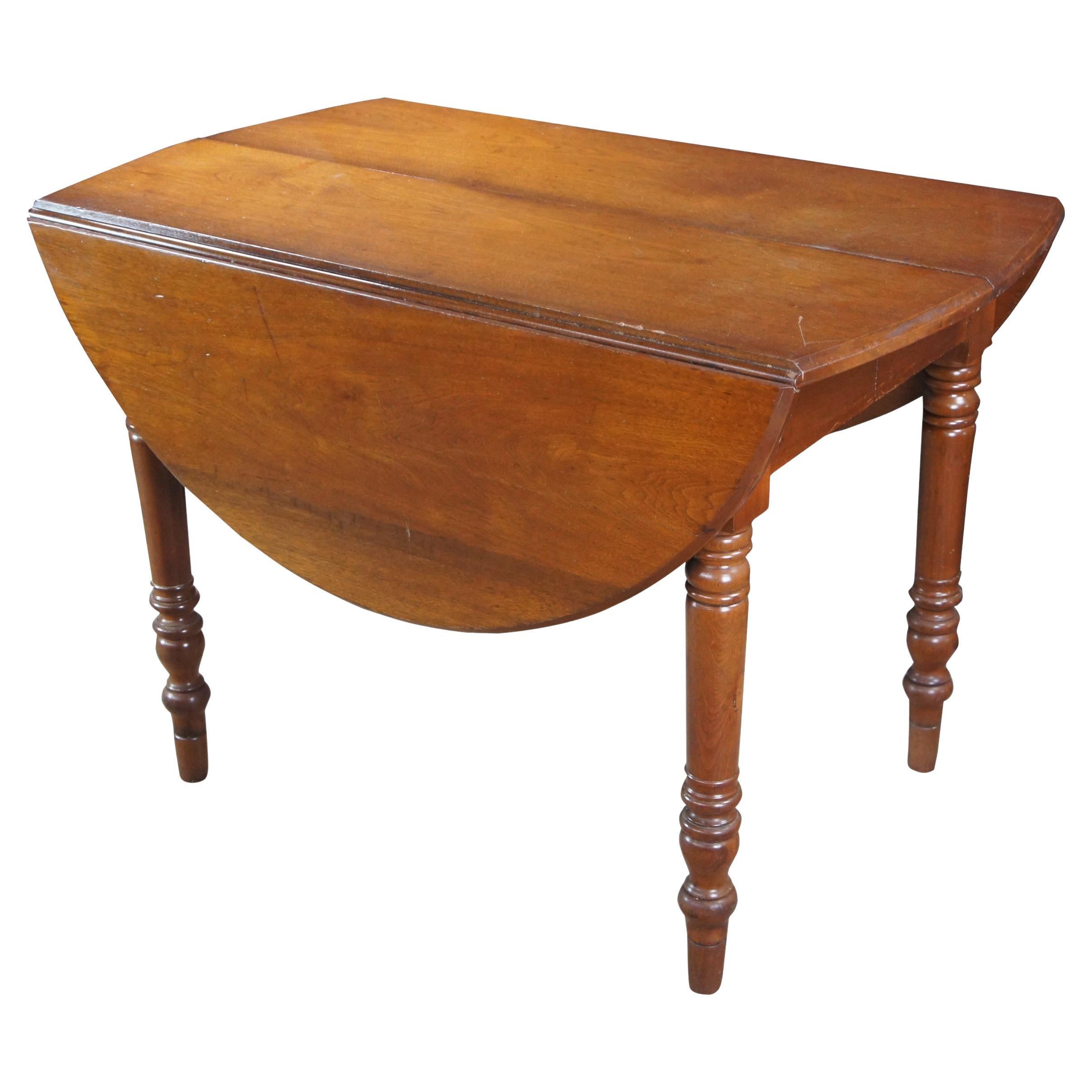 Late 19th Century drop leaf extendable breakfast or dining table.  Made from American mahogany with ring turned legs leading to arrow feet.  Includes one extendable leaf.  The table is oval once the leaves are up.  

Dimensions:
43