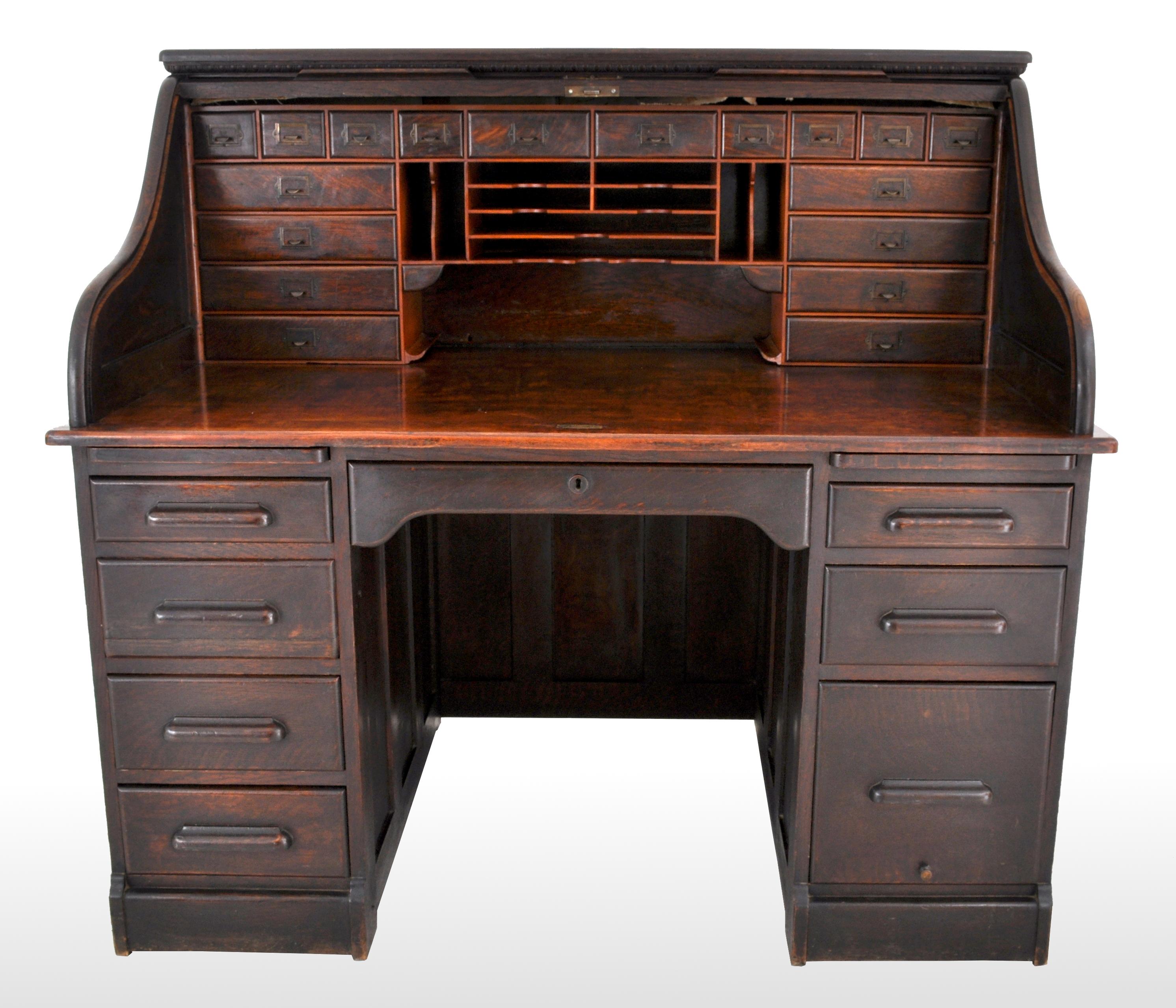 A good antique American oak roll top 's Curve' Tambor desk, circa 1880. The desk having a band of 'egg & dart' molding with a pronounced 's Curve' tambor below. The roll top enclosing a bank of 17 drawers and vertical and lateral files and two