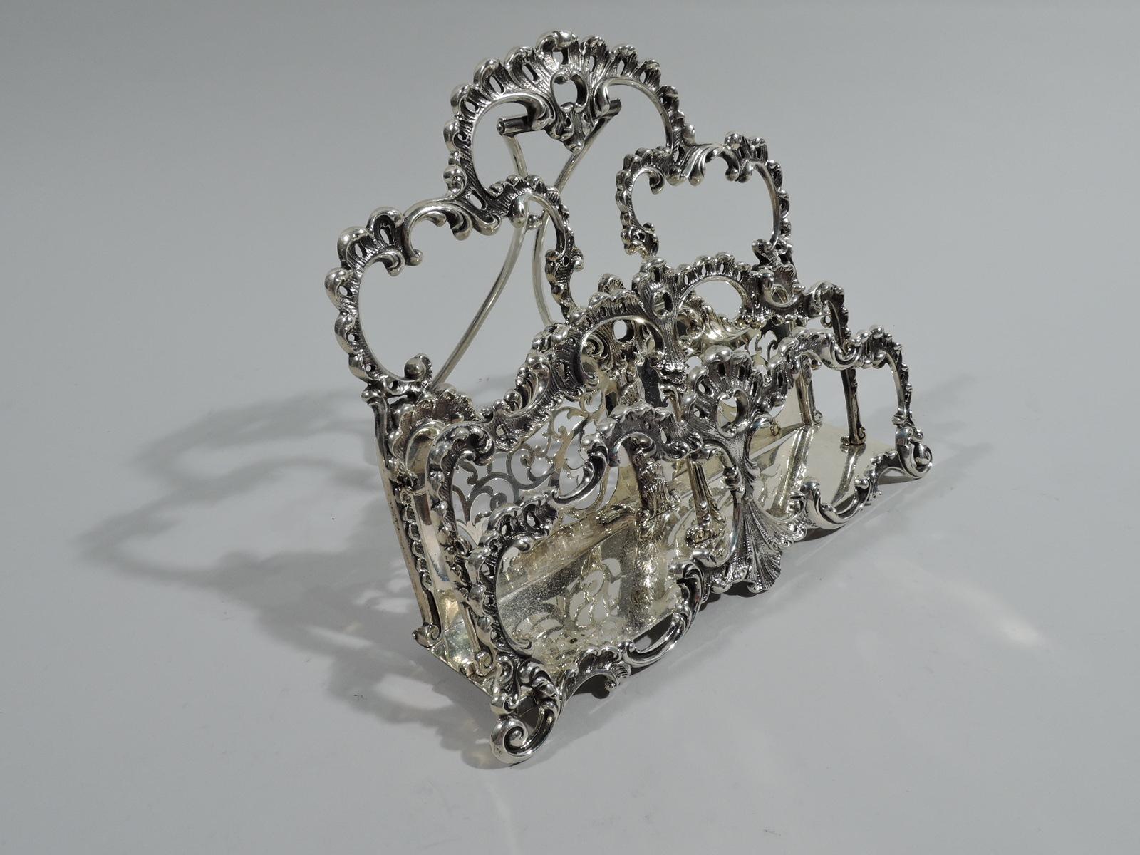Victorian Rococo sterling silver letter rack. Made by Howard & Co. in New York, ca 1890. Three open partitions in form of pierced and leafing scrolled cartouches mounted to plain and solid rectangle. Back partition has open scrollwork set in in