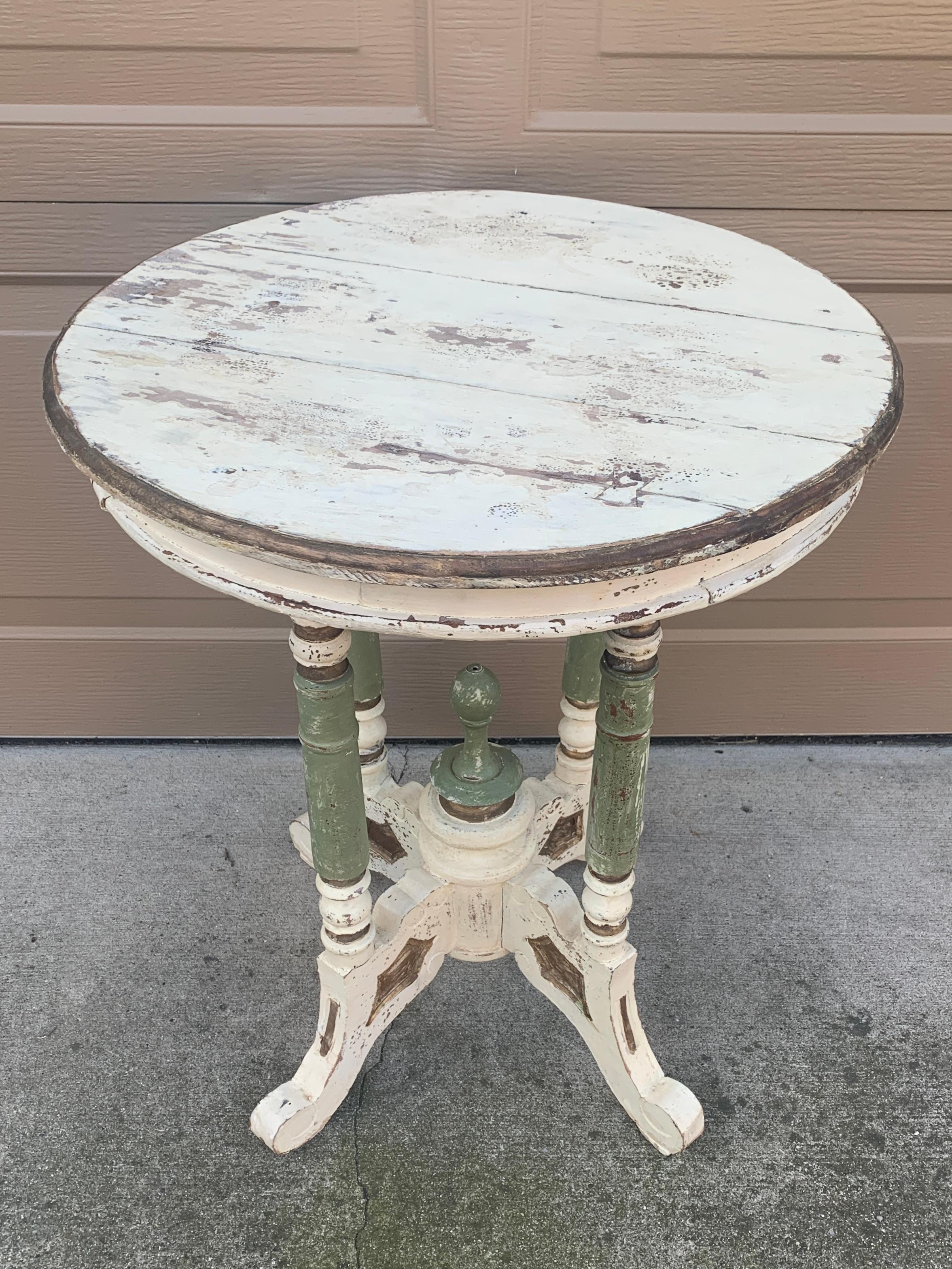 A gorgeous Victorian round side table on four legs

USA, Circa late 19th century

Painted carved walnut in antique white, light green, and gold.

Measures: 19.5