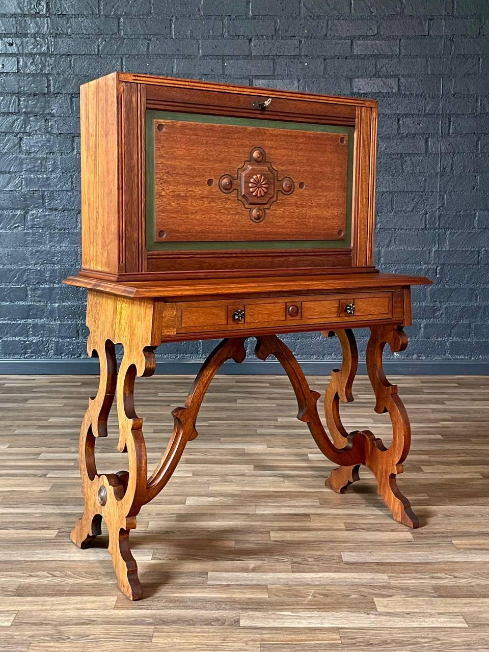 Condition: Original Vintage Condition 
Materials: Walnut, Mahogany, Brass Skeleton Key, Patinated Brass Pulls
Style: American Victorian

This antique American Victorian secretary desk showcases exquisite craftsmanship with its intricate scroll-cut