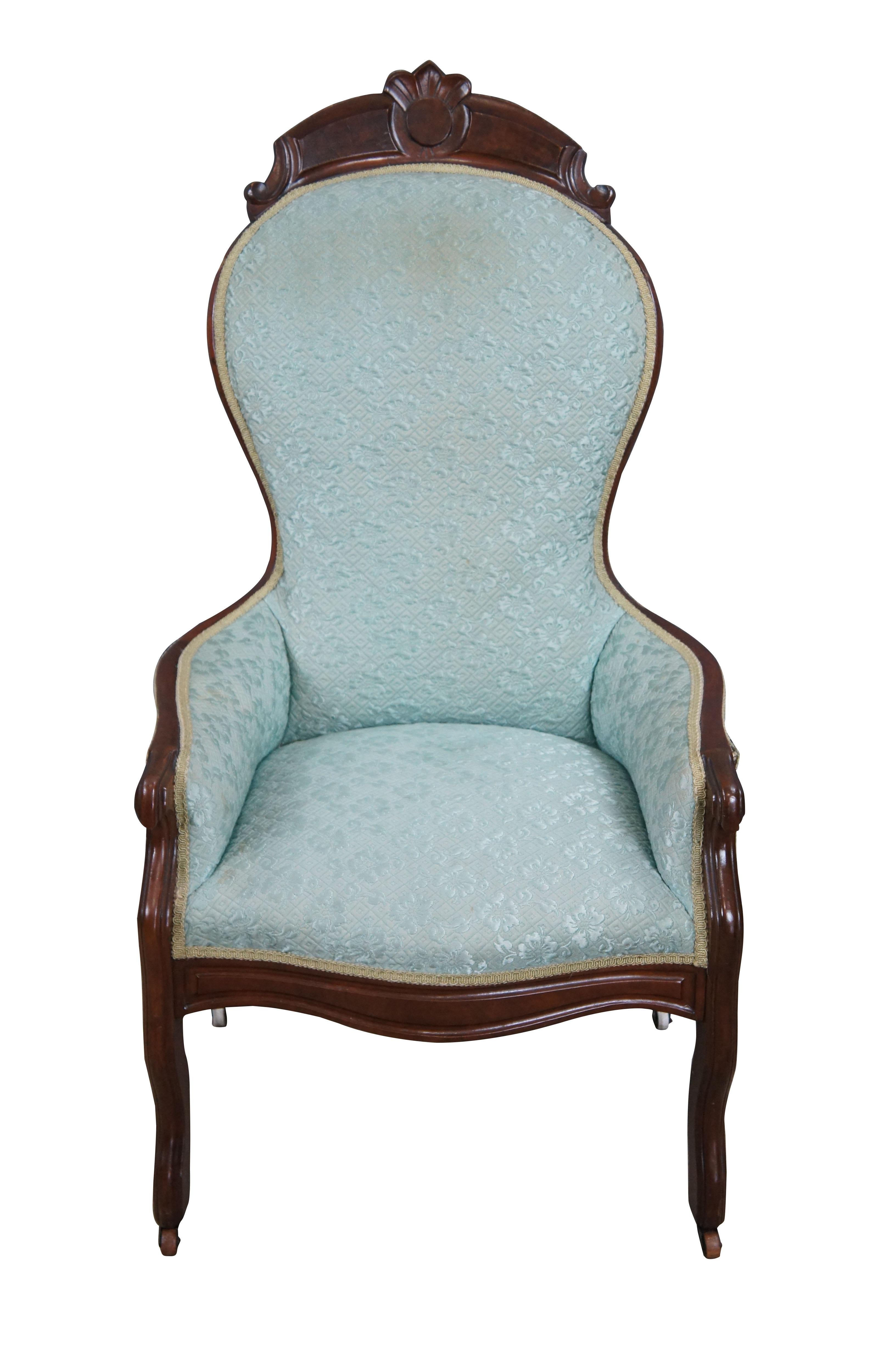 Antique Victorian balloon back arm chair.  Made of walnut featuring high back with paneled foliate crest, low arms and serpentine legs with castors.  Upholstery by Shillito's Department Store in Cincinnati.  Shillito's was the first department store