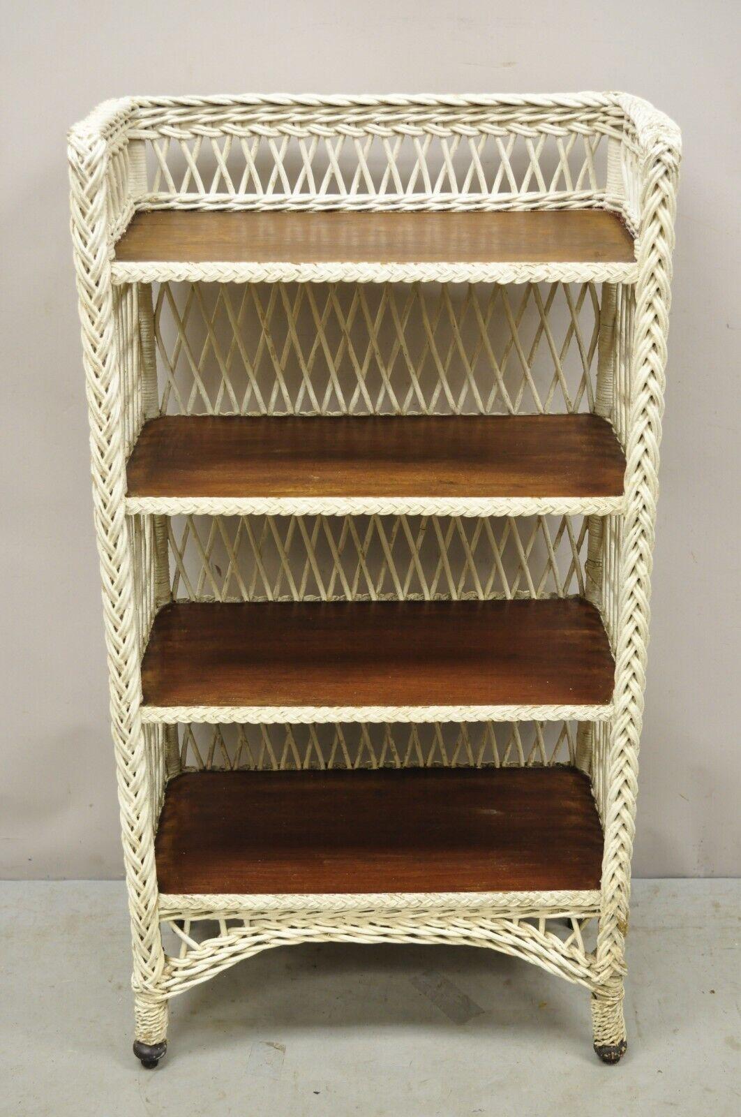 Antique American Victorian White Wicker 5 Shelf Bookcase Curio Display. Item features a white painted wicker frame, 4 wooden shelves, very nice antique item, quality American craftsmanship, great style and form. Circa Early 1900s. Measurements: 48