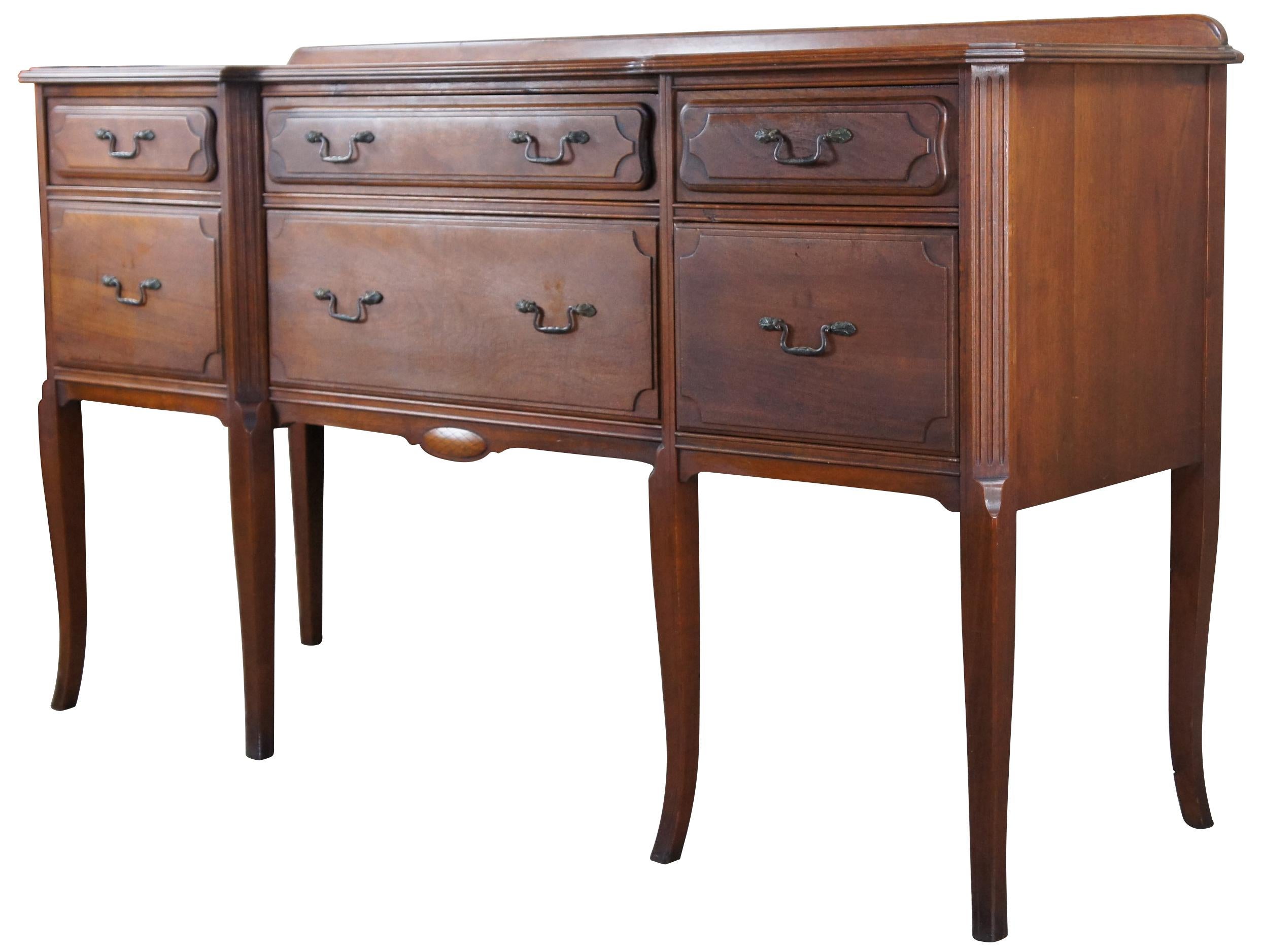 An early 20th century American Sideboard. Made of walnut with rectangular form that features a narrow backsplash and 6 dovetailed drawers of oak construction. Includes Chamfered fluted stiles terminating into rams tongues and tapered flared legs. A
