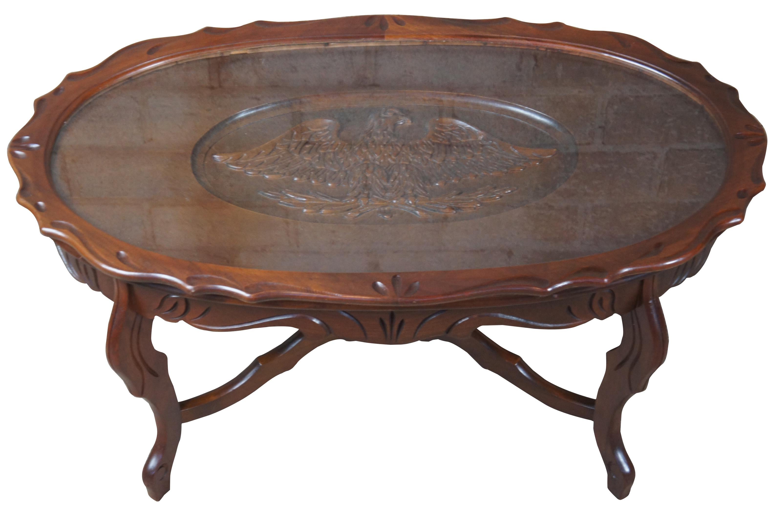 Early 20th century walnut carved tray table. Features a scalloped top, serpentine apron, and cabriole legs connected by serpentine stretchers with center finial.
   