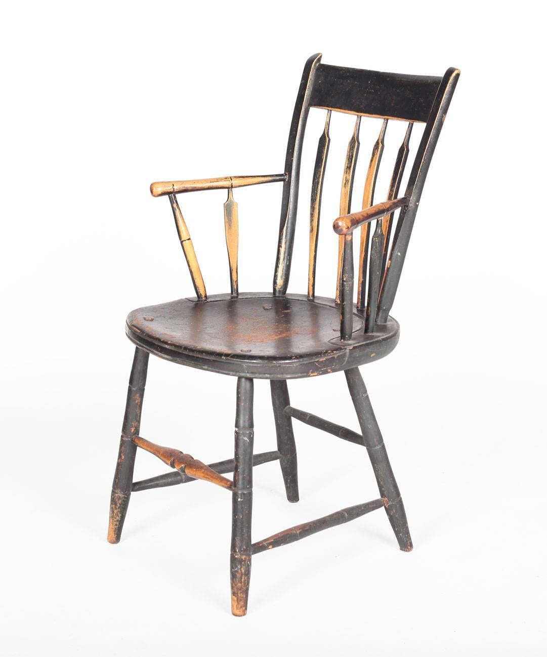 An American windsor chair featuring the original paint, dating to the 19th century. The chair measures 20 inches wide by 17 inches deep and 33 inches high.