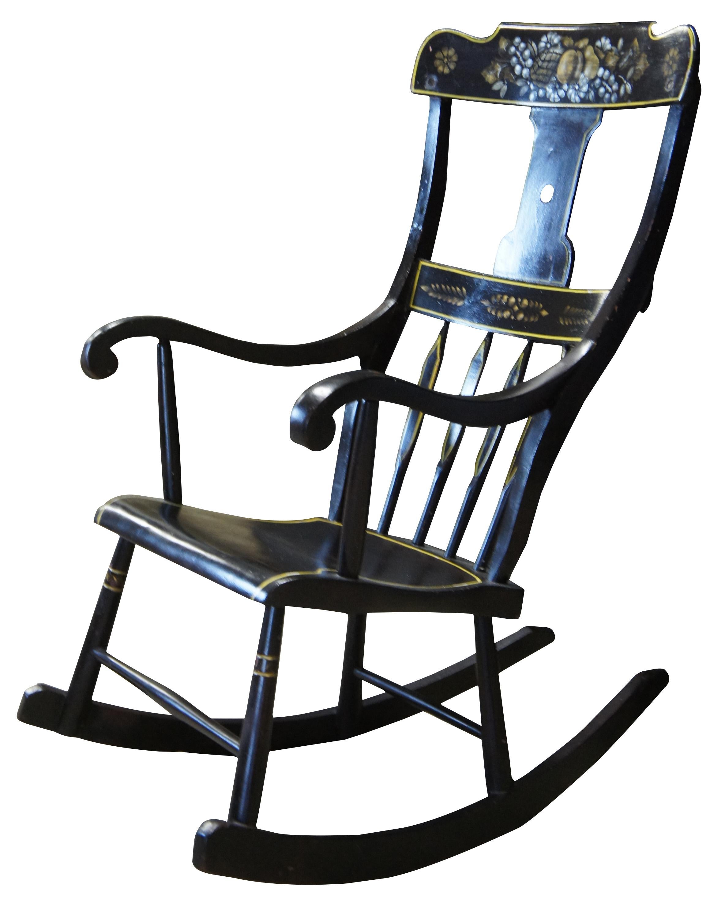 Antique 19th century Boston rocker. Features a black painted finish with hand stencilled fruit and flower deisgns. Includes a contoured rail over a pierced splat and lower rail over spindles leading to scrolled arms and a shaped seat.
     