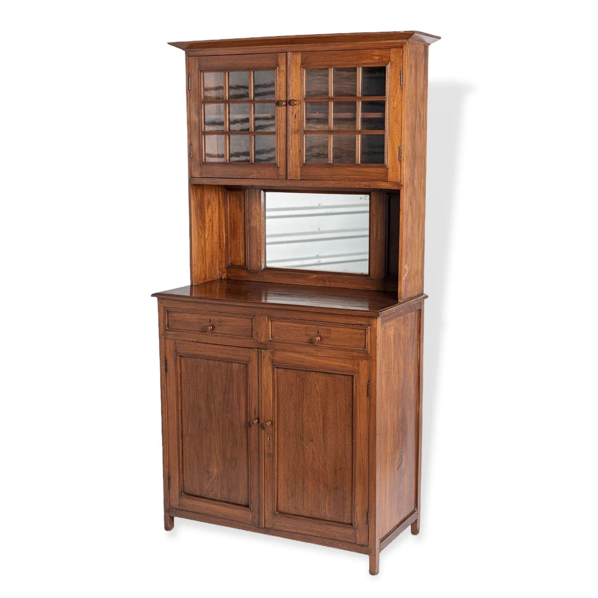 This incredible handcrafted late 19th century antique American solid wood farmhouse cabinet is perfectly aged with great rustic character. The unique and elegant design of this two-piece cabinet features an upper step-back hutch with nine glass pane