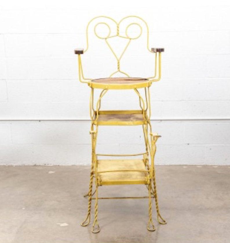A fabulous American Victorian painted yellow wrought iron wire Grand shoe shining stand by Royal Products Chicago.

Born in the late 19th century, the tall shoeshine chair is styled in period 