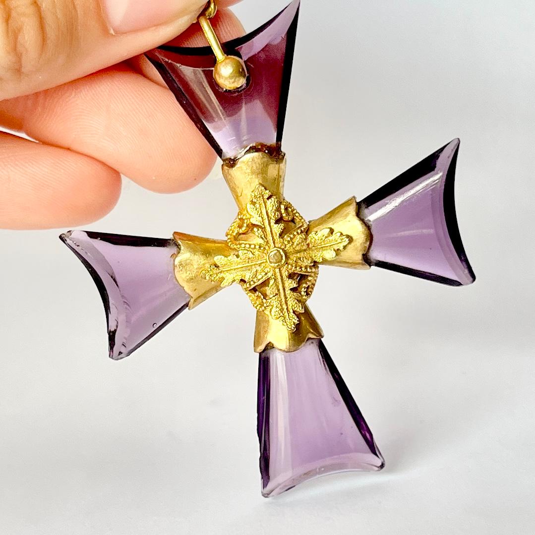 This gorgeous pendant is made up of four pieces of amethyst and ornate gold work at the centre. The is a little damage to one of the stones as you can see in the images. However the worn it is un noticeable. 

Cross Dimensions: 59x51mm

Weight: 14.4g