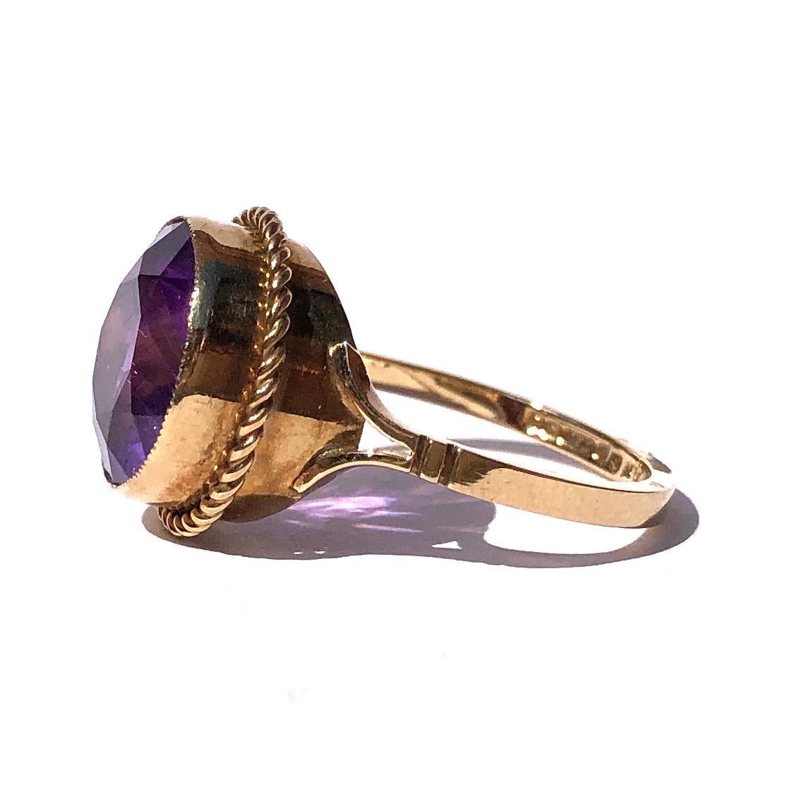 The colour of this amethyst is simply stunning and such a bright shade of purple. The stone is set in a simple setting with rope twist detail and then carries down to split shoulders. Made in Birmingham, England. 

Ring Size: O 1/2 or 7 1/4 
Stone
