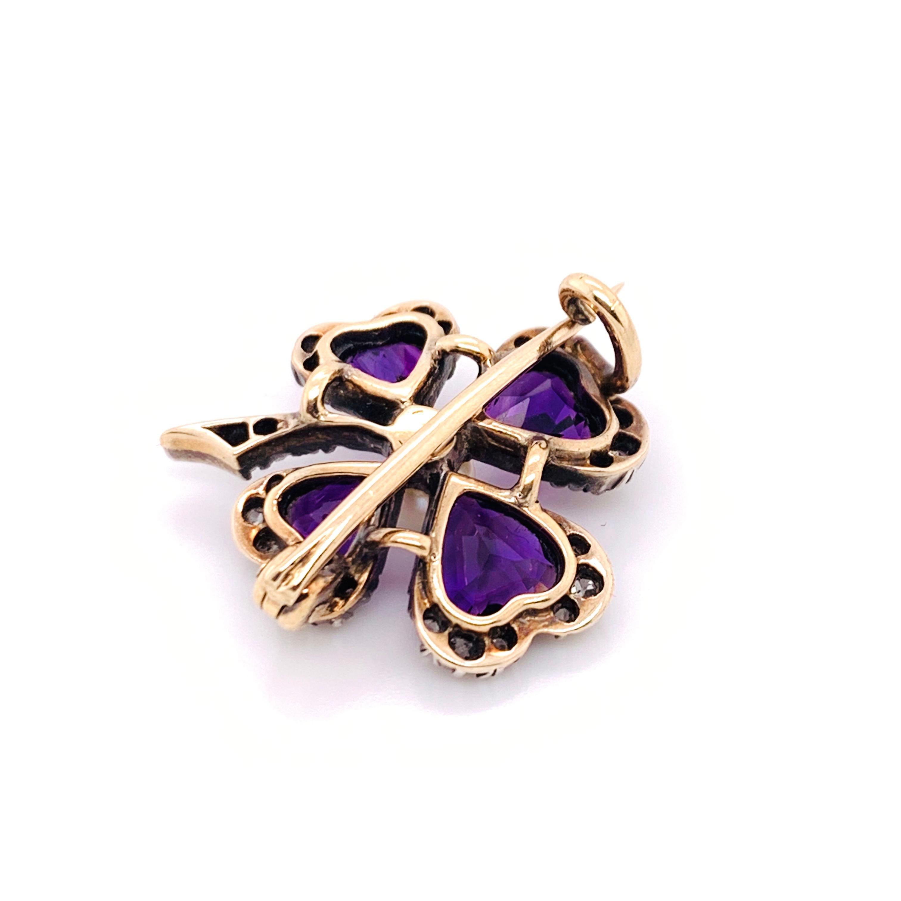 A Victorian amethyst and diamond four leaf clover brooch, with a natural pearl in the centre, with four pear shaped amethysts, edged with old-cut diamonds in cut down settings, mounted in silver-upon-gold. English, circa 1890.