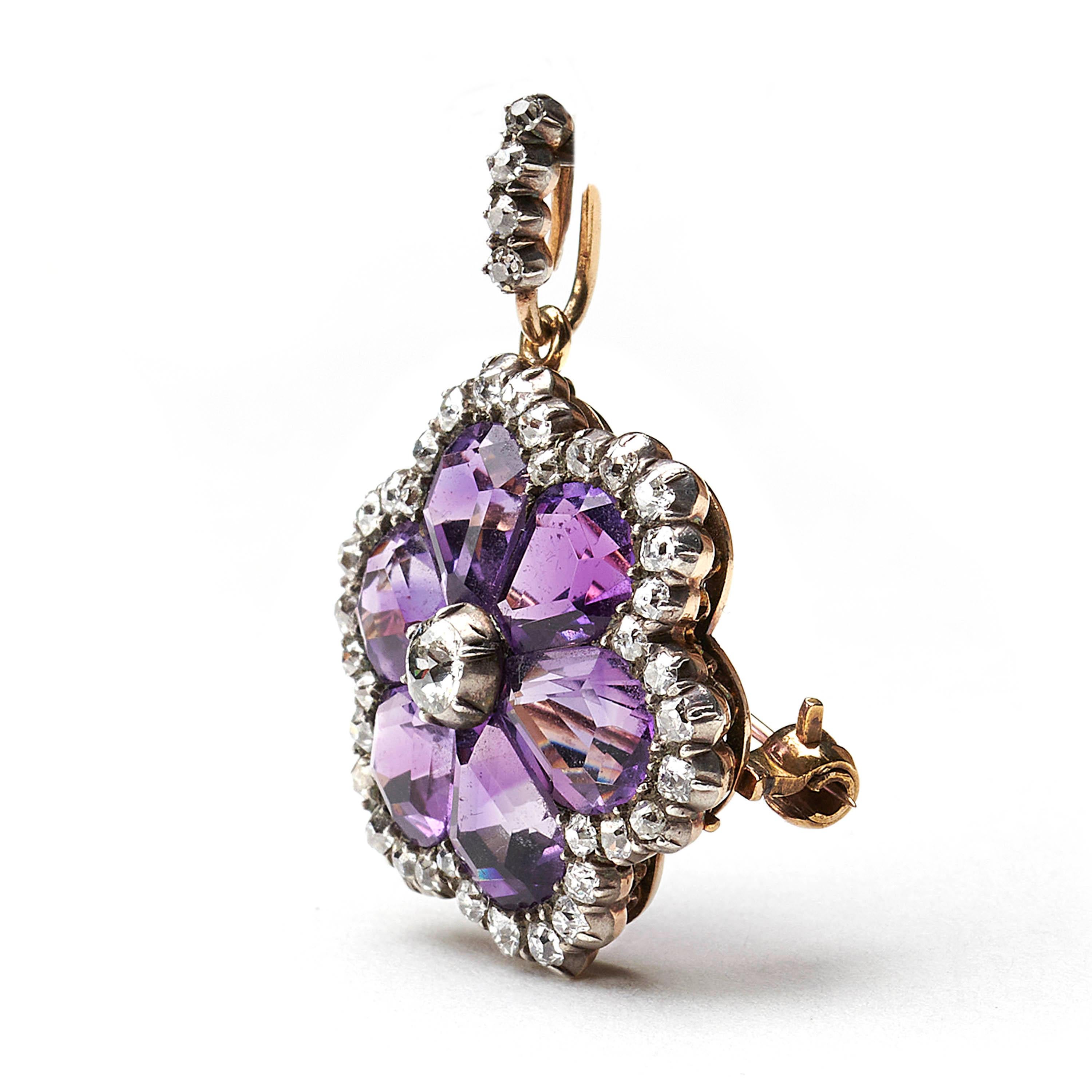 An antique, amethyst and diamond, flower cluster brooch-cum-pendant, set with a central old-cut diamond, in cut-down settings, with six, fancy, pear shaped amethysts, forming petals, surrounded by old-cut diamonds, in cut down settings, mounted in