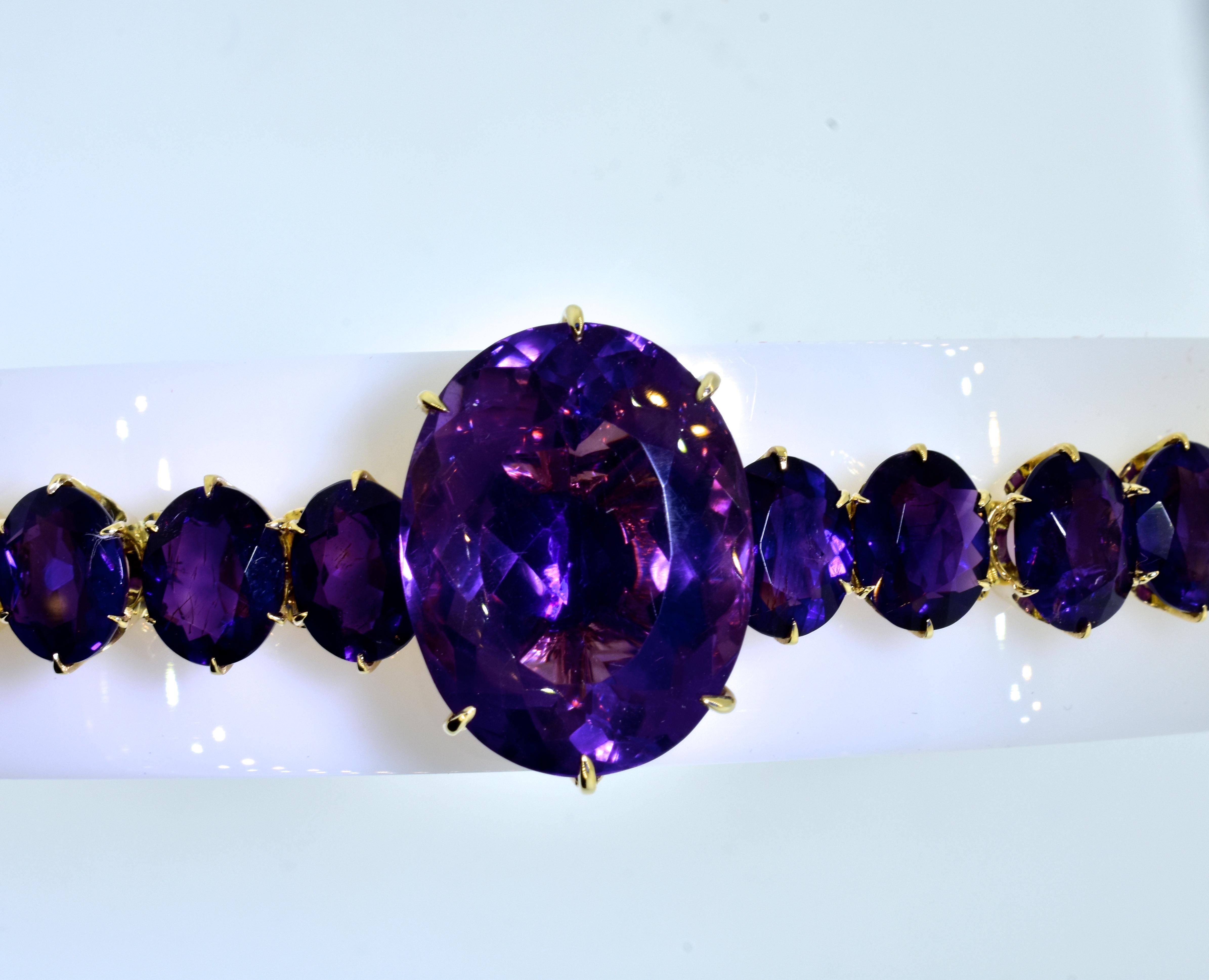 19th Century antique gold bracelet possessing finely matched purple amethysts.  The total weight of the very fine amethysts is estimated to be 150 cts.  The large center stone is set with elaborate prongs and gallery hand work, it is estimated to