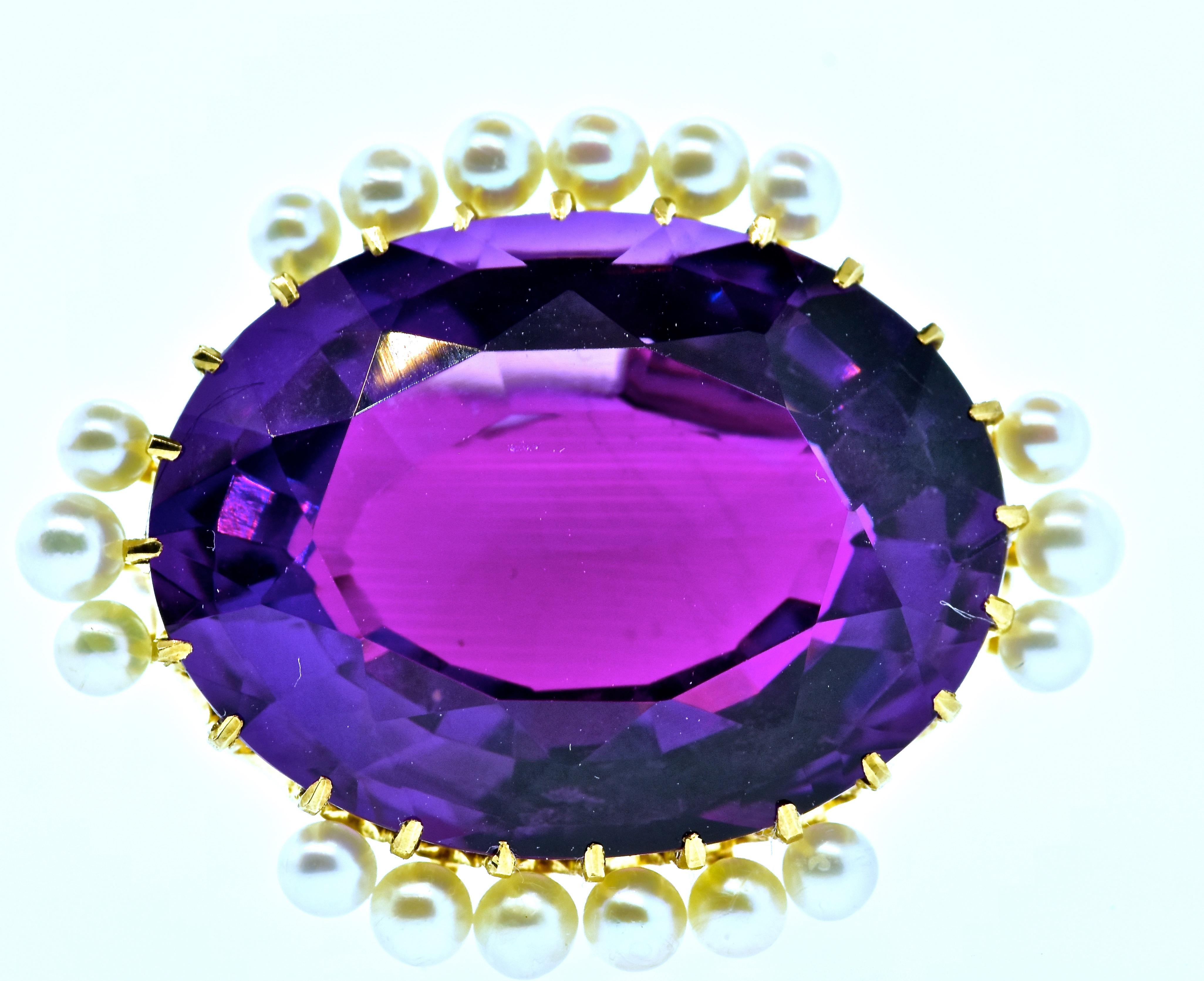 Antique pin centering a large oval natural bright purple (with no unwanted muddy tones) amethyst estimated to weigh over 22 cts.  There are 18 natural oriental round pearls, measuring 2-3 mm.  These pearls display a high luster and are uniform in