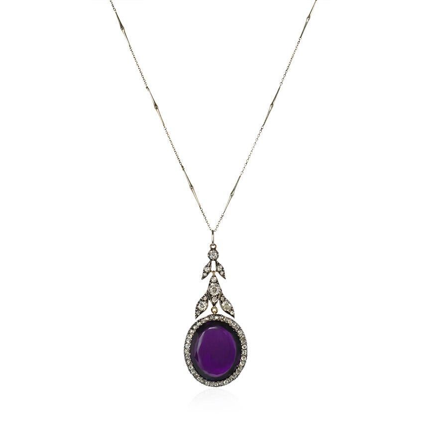 An antique 19th century amethyst pendant in an old-mine-diamond surround suspended from a diamond girandole surmount of foliate design, in sterling silver and 18k gold.  Atw 2.48 cts.  Chain included but likely not original to the pendant.  Pendant