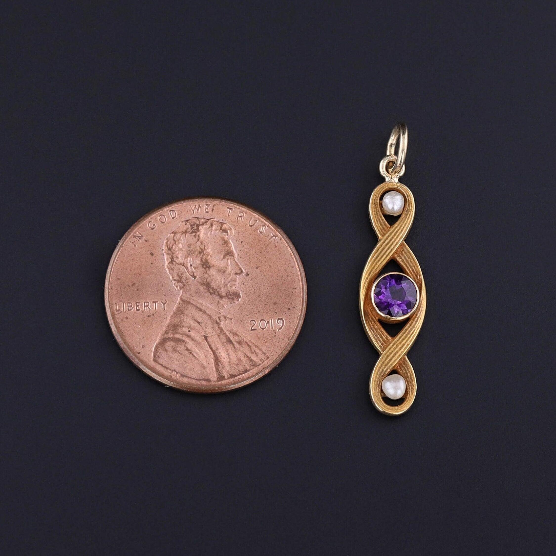 Antique Amethyst and Pearl Pendant in 10k Gold, Converted from Edwardian Pin (circa 1915)

This elegant antique pendant showcases the romantic charm of the Edwardian era, featuring a vibrant amethyst gemstone paired with two luminous pearls, all set