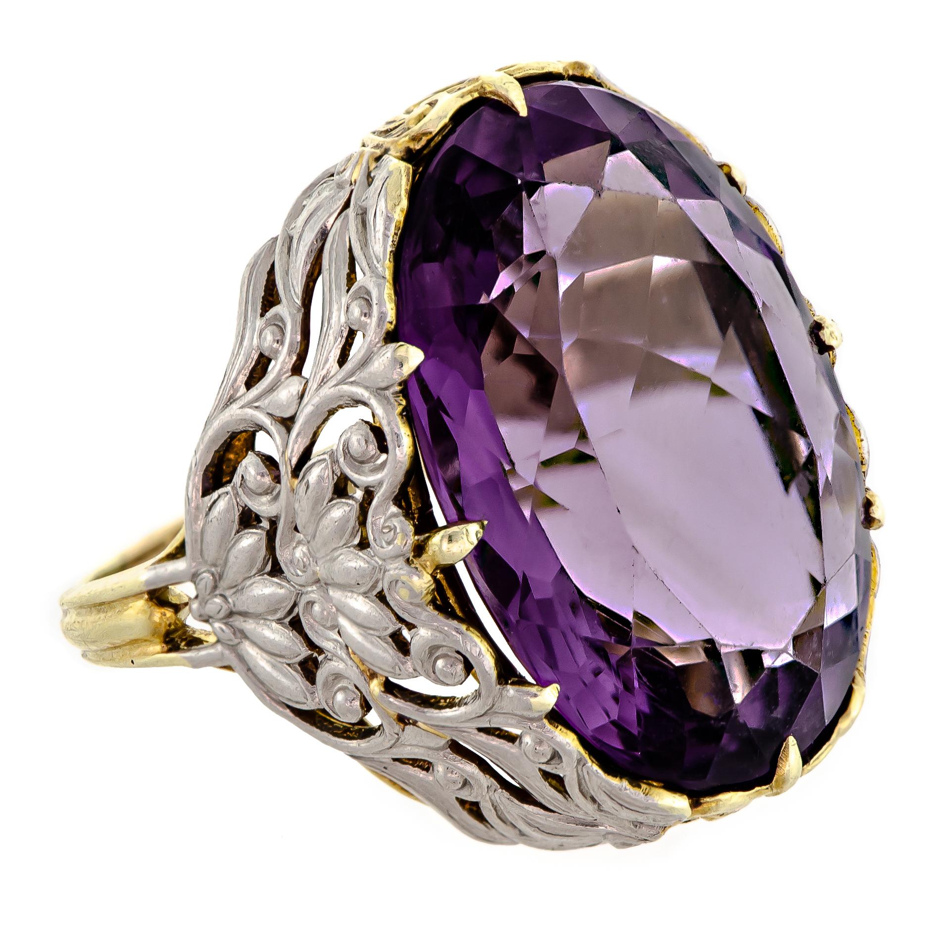 Exquisite antique amethyst and two-colored gold ring - centrally set with one large oval-shaped brilliant-cut rich deep colored purple amethyst measuring approximately 23.1mm x 18mm set into a lovely two-colored gold yellow and white - 14kt frame -