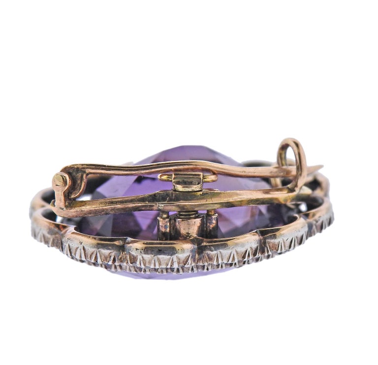 Antique 18k gold and silver brooch/pendant, with 20mm x 16.2mm x 11.5mm amethyst, surrounded with diamonds. Brooch measures 28mm x 25mm. Weight - 10 grams. 