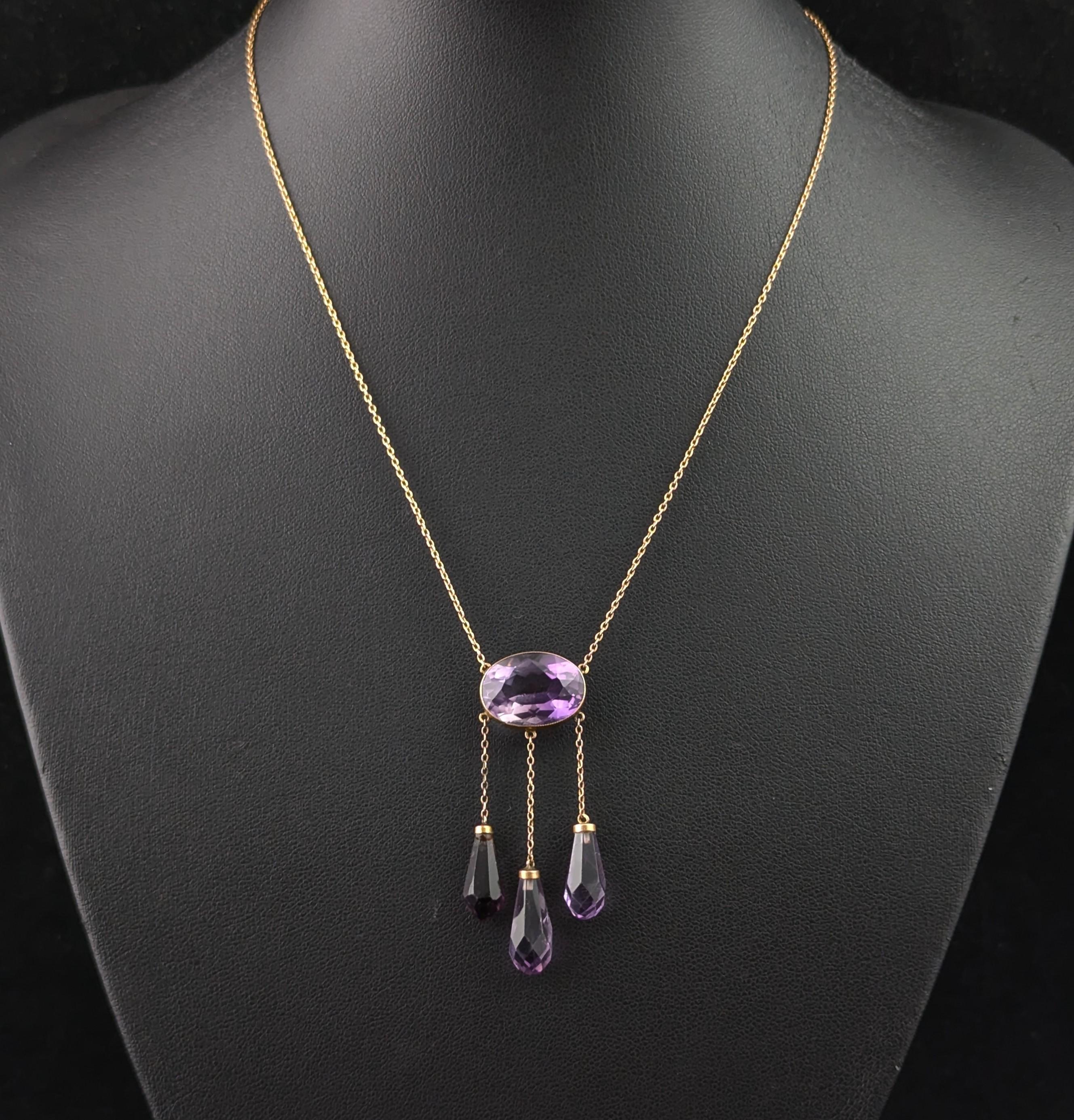 A truly stunning antique necklace is what you will find with this gorgeous Amethyst and drop necklace.

Crafted in rich 9ct yellow gold it has a bold yet delicate look with simple gold settings and lush, rich gemstones.

The centre features a