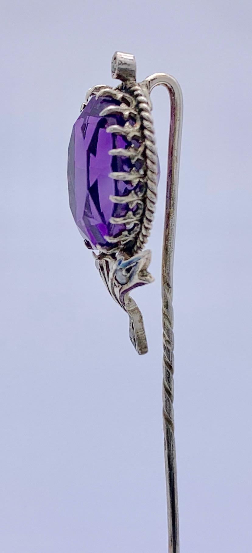 Charming late 19th century stick pin in the shape of a flower set with an intensive purple amethyst and small natural pearls.