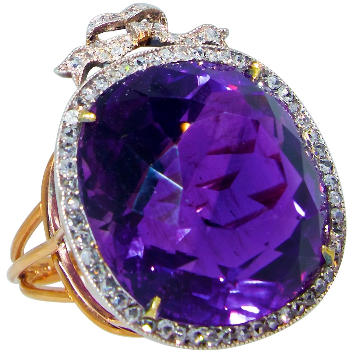 Antique ring in silver and gold possessing a very fine natural Siberian amethyst displaying  a pure royal purple color with a hint of red - the classic Siberian color seen in 19th century jewelry.  This center stone weighs approximately 28.5 cts and
