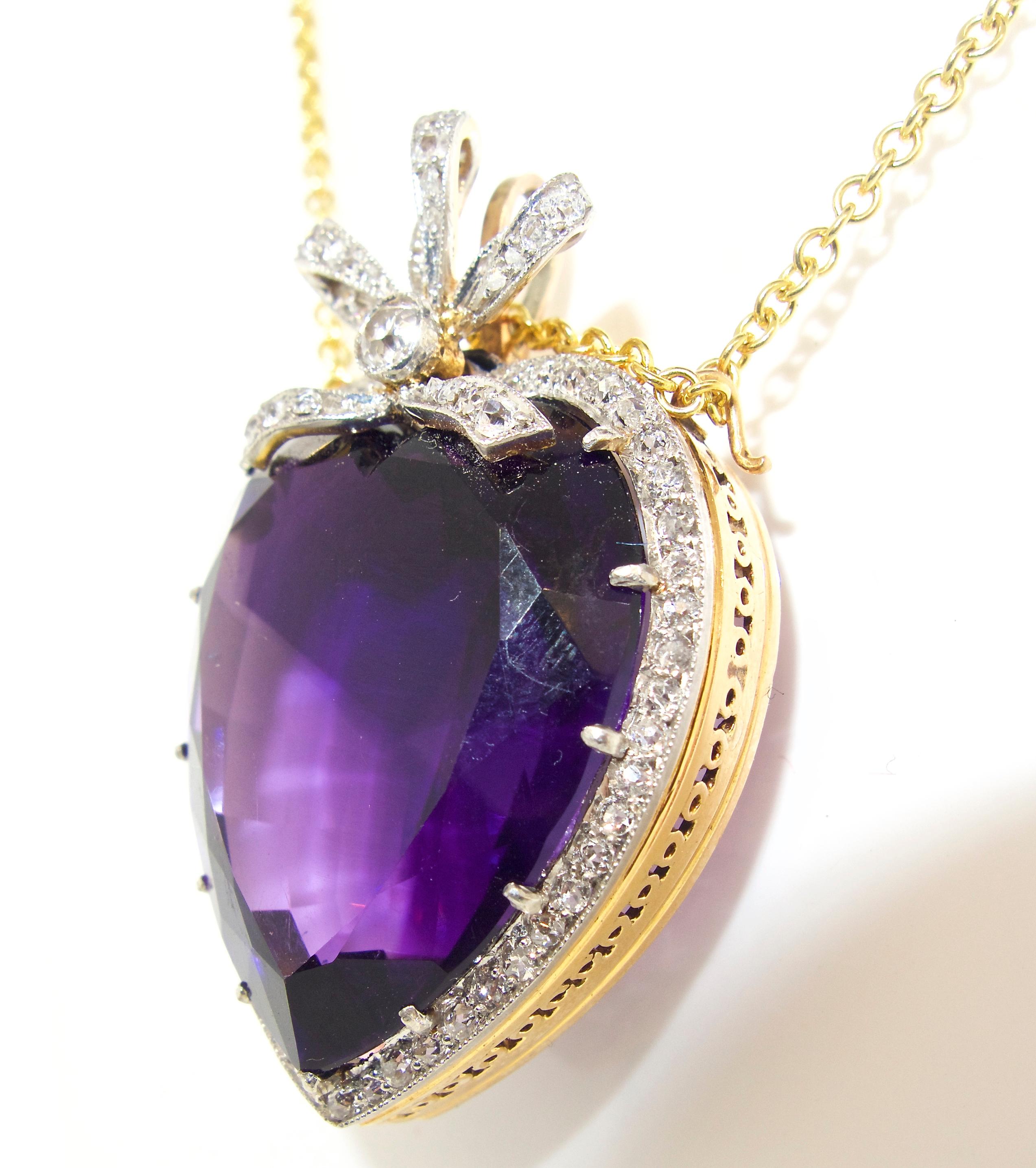 The center deep violet purple amethyst is from the Siberian area of Russian, it weighs 20 cts., approximately.  This center heart shaped stone is surrounded and accented by 80 old cut white diamonds.  This pin/pendant is suspended on a gold chain