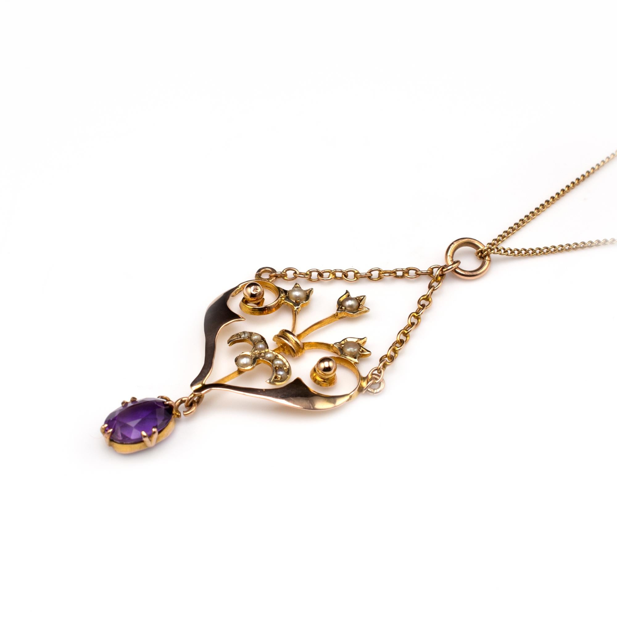 This delightful gold pendant is beautifully decorated with amethyst and pearls and dates back to the early 20th century.

The heart-shaped gold frame is beautifully crafted with graduating scrolls and ball decoration. The central display of tulips