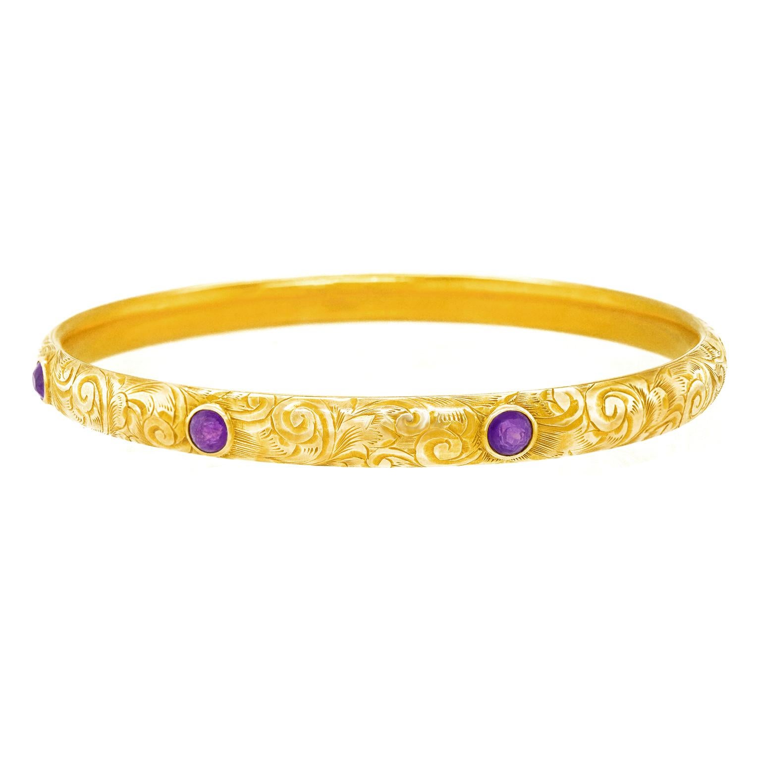 Circa 1900, 14k, by Bippart, Griscom & Osborn of New Jersey.   This beautiful turn-of-the-century bangle features a hand-engraved Florentine motif set with three beautiful amethysts. Delightfully antique-chic, it looks amazing worn alone or layered