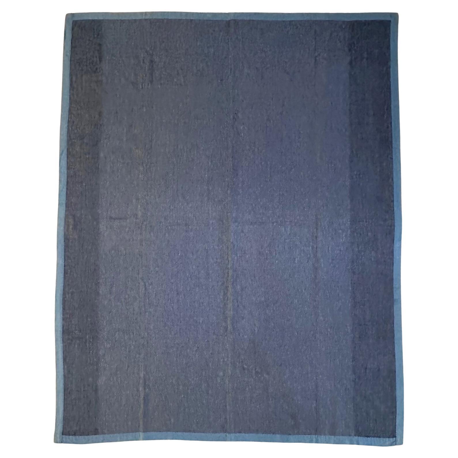 A large Amish quilt of center bars pattern made from a striking combination of contrasting colors: light blue, maroon red and blush pink. Bordered with teal blue and backed with cotton. The seven bars in the center with alternate colors is confined