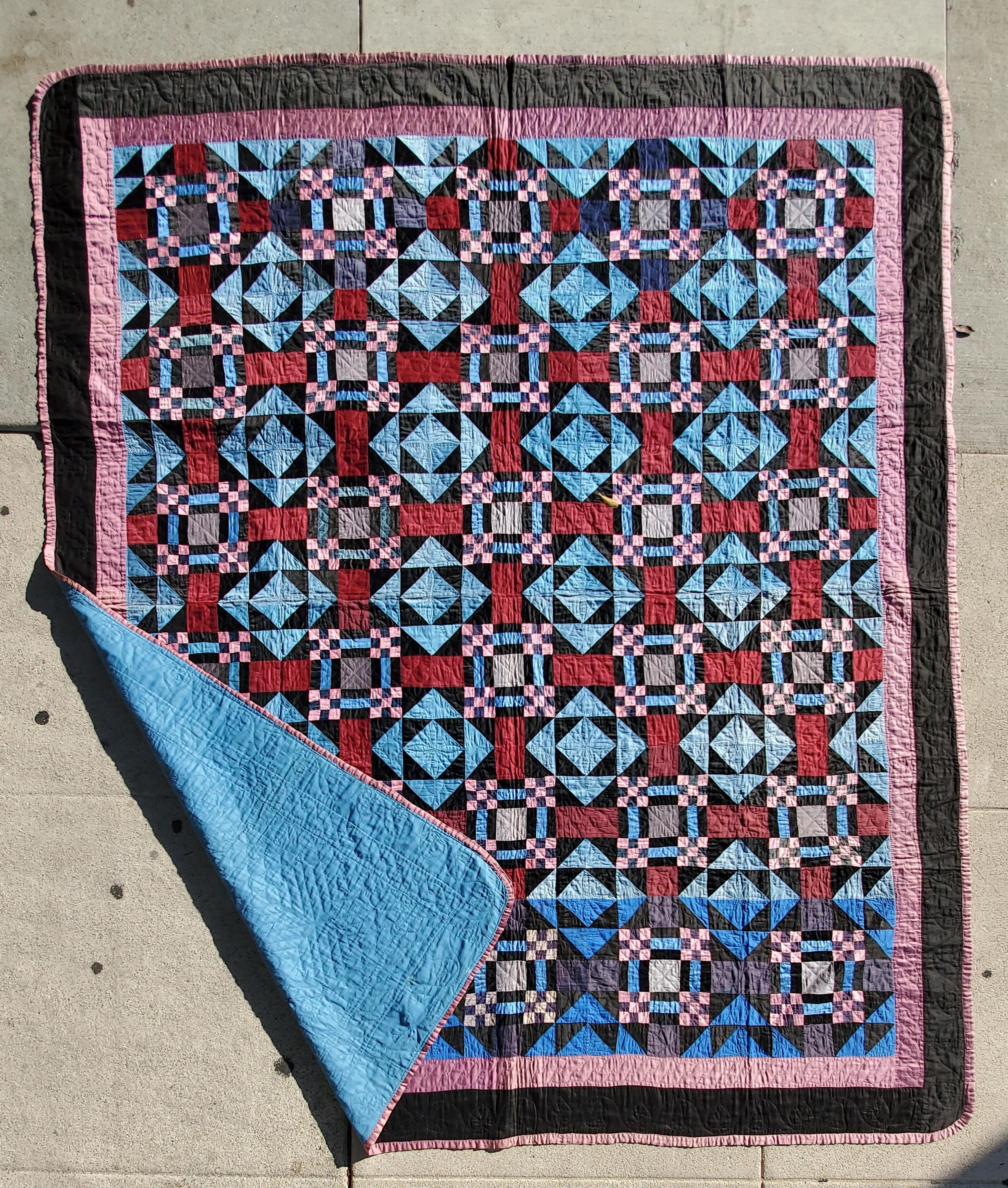This fine Ohio Amish quilt is in pristine condition and is made from polished cotton. The fine piecework of the postage stamp nine patch corners and geometric pattern surround. It is from the thirties.Fantastic quilt !
