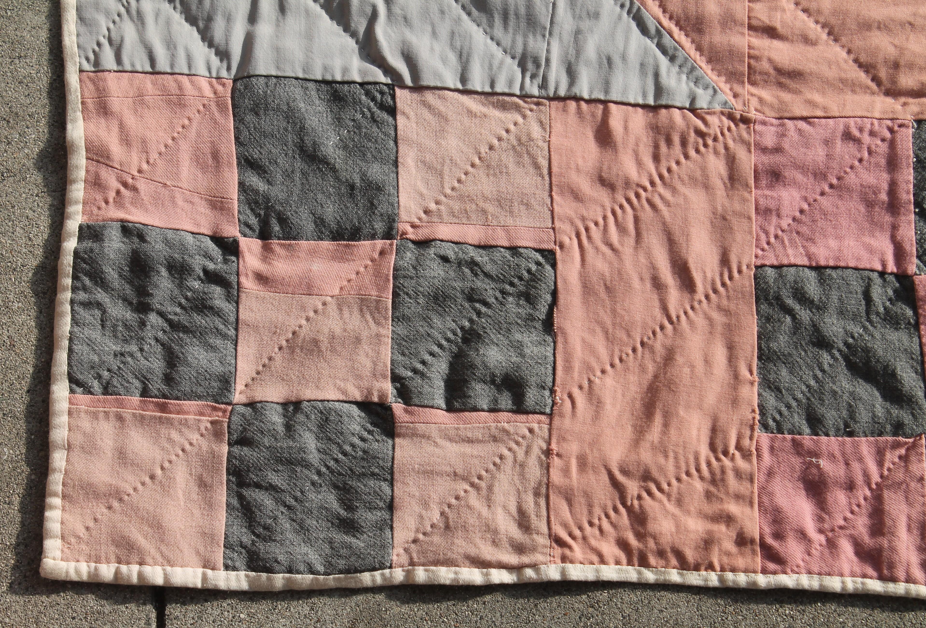 This cool colors wool nine patch quilt is in very somber colors and good condition. It was made in Mifflin County, Pennsylvania. The soft grey and salmon colors work very nicely together.