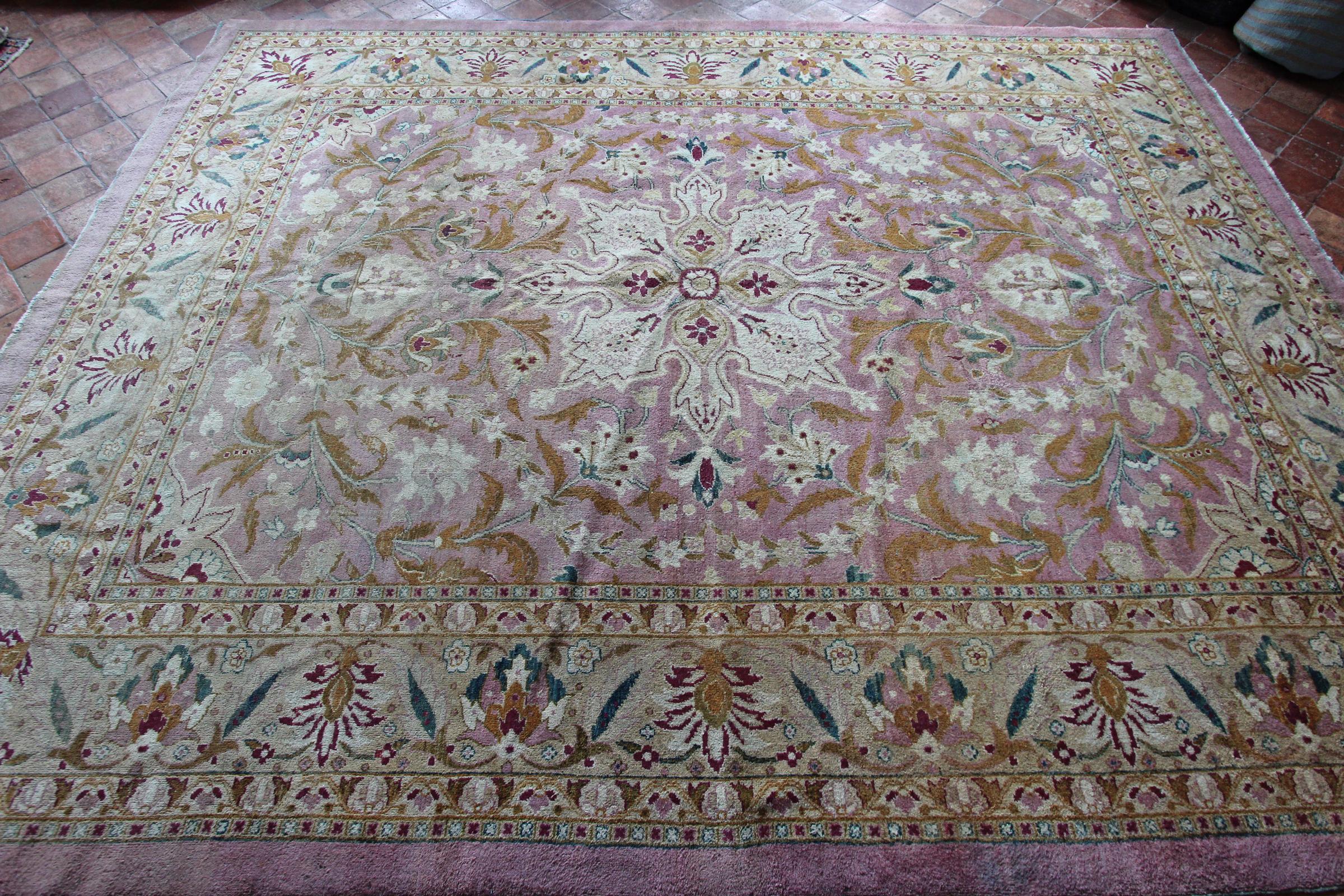 An exquisite design and elegant soft rare colors on this antique Amritsar carpet woven in the late 19th century. A subtle variety of pink dyes are used for the main field color and outer border to frame this classical medallion design. Scrolling