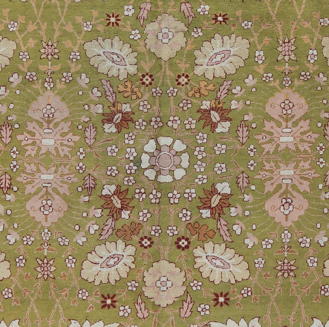 A finely woven Amritsar carpet with a rare avocado green field and soft pink border. An open, all-over floral design. A medium, soft wool pile that is fantastic under foot. This turn of the century carpet is naturally dyed and in beautiful condition