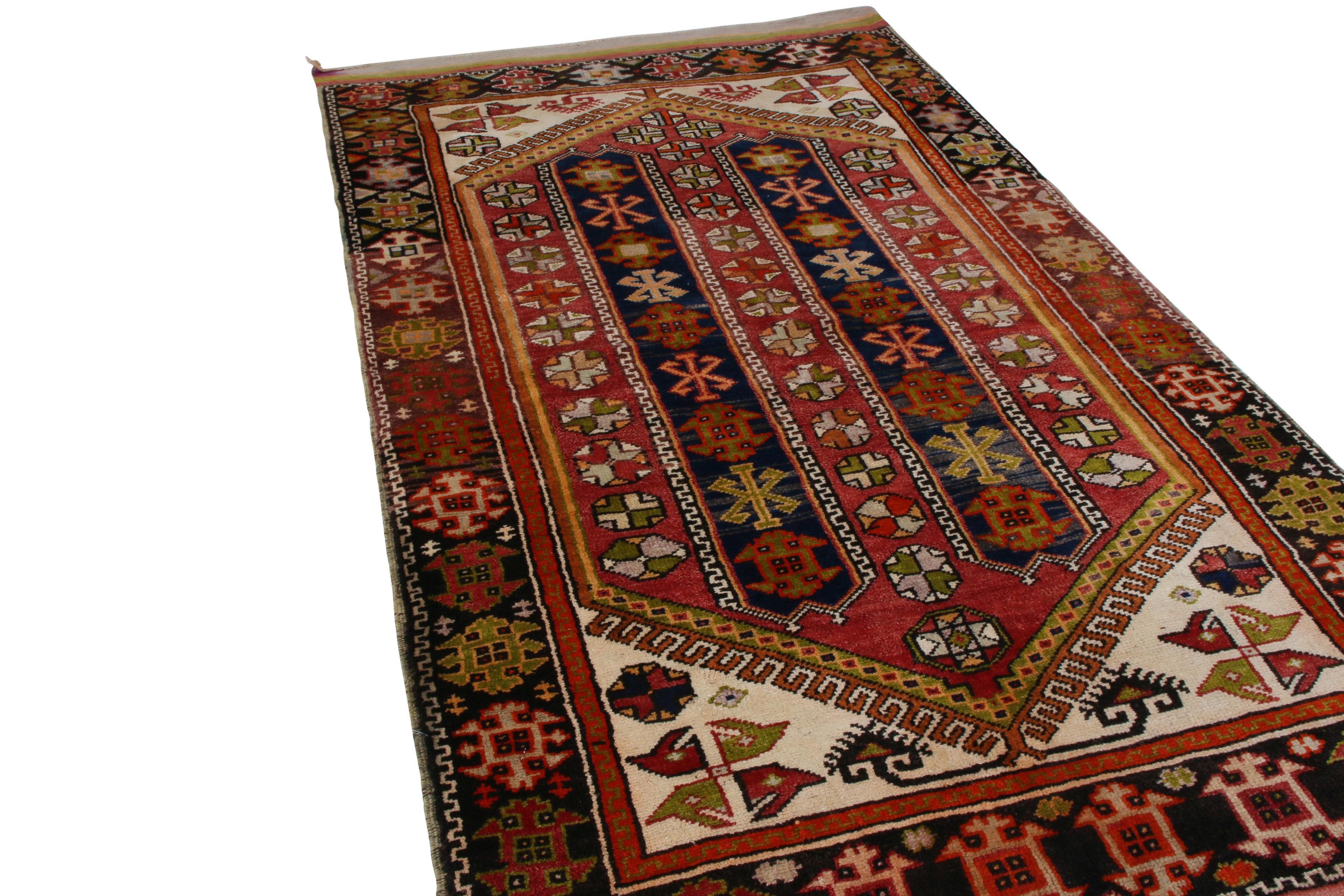 Made with hand knotted wool and originating between 1900-1910, this antique rug is derivative of an Anatolian transitional geometric design, creating a celebratory mood with the play of more joyful notes of red, blue, beige and yellow recapturing a