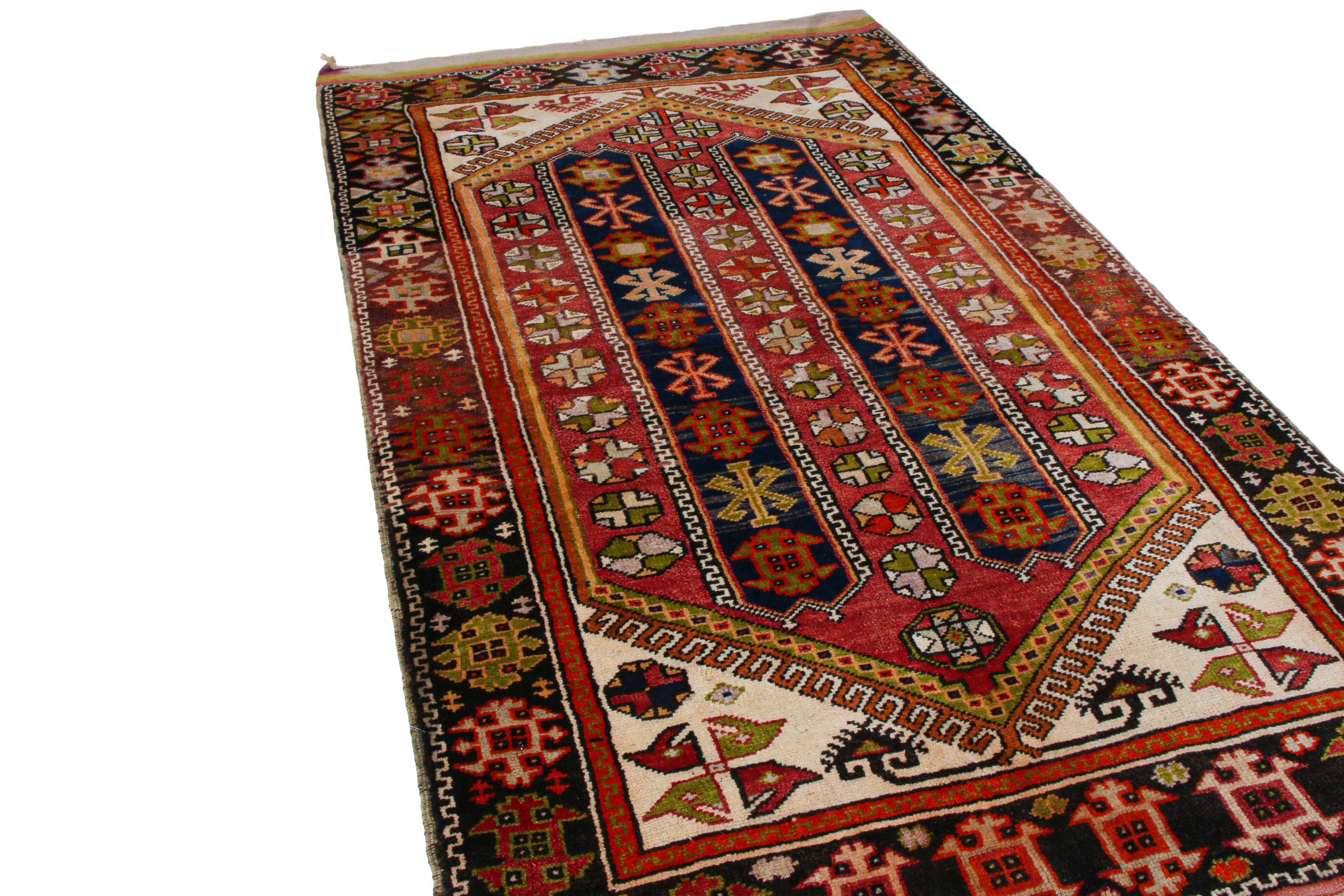 Made with hand knotted wool and originating between 1900-1910, this antique rug is derivative of an Anatolian transitional geometric design, creating a celebratory mood with the play of more joyful notes of red, blue, beige and yellow recapturing a