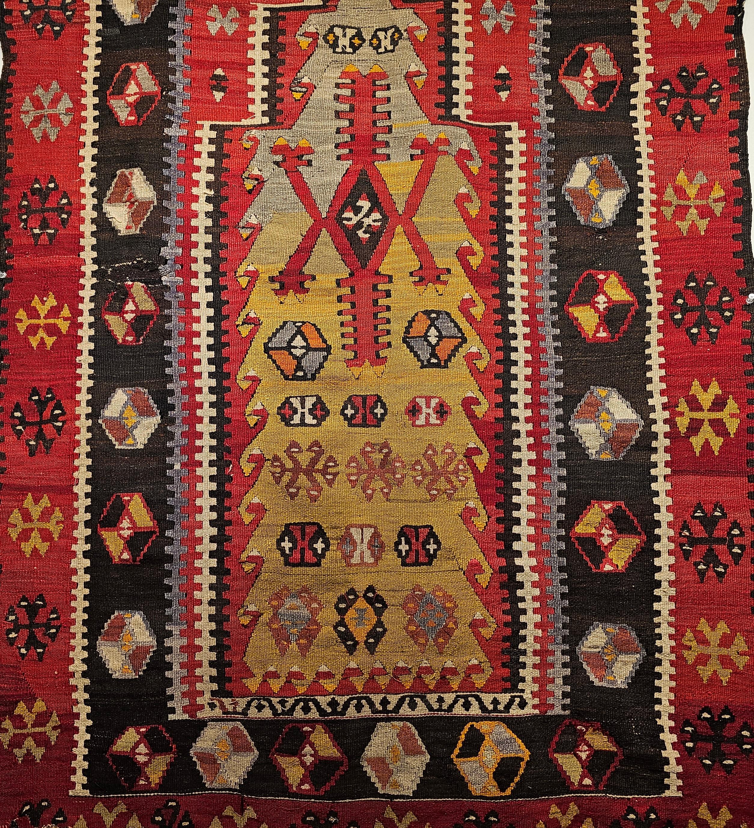 A beautiful Anatolian Kilim in prayer rug pattern from the early 1900s in abrash green, yellow, red, and black colors. The beautiful green in the Mihrab (prayer niche) design of this antique Turkish Kilim adds to the uniqueness of this small antique