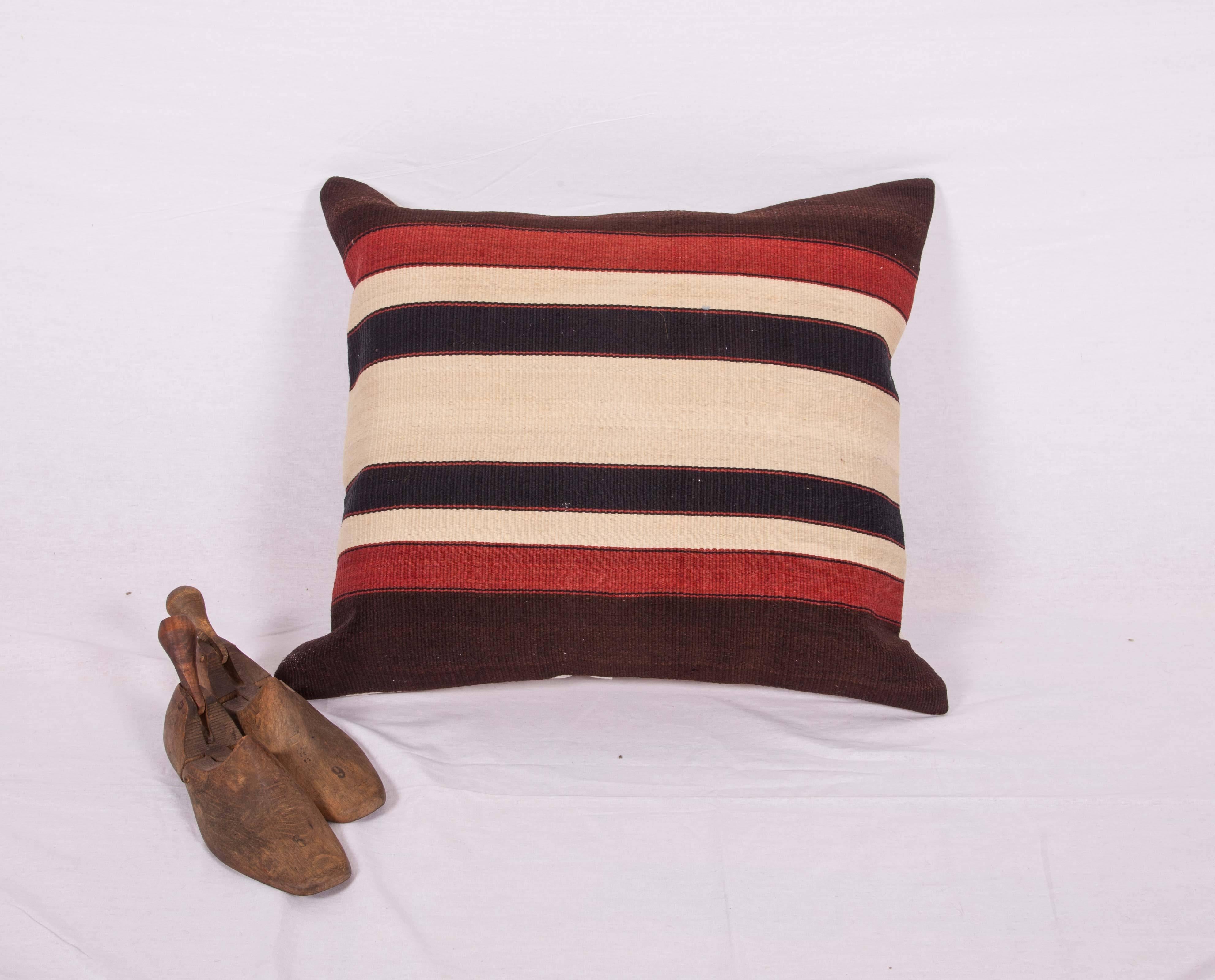 The pillow case is made from an antique Anatolian kilim. It does not come with an insert but comes with a bag made to the size and out of cotton to accommodate the filling. The backing is made of linen. Please note filling is not provided. Since the