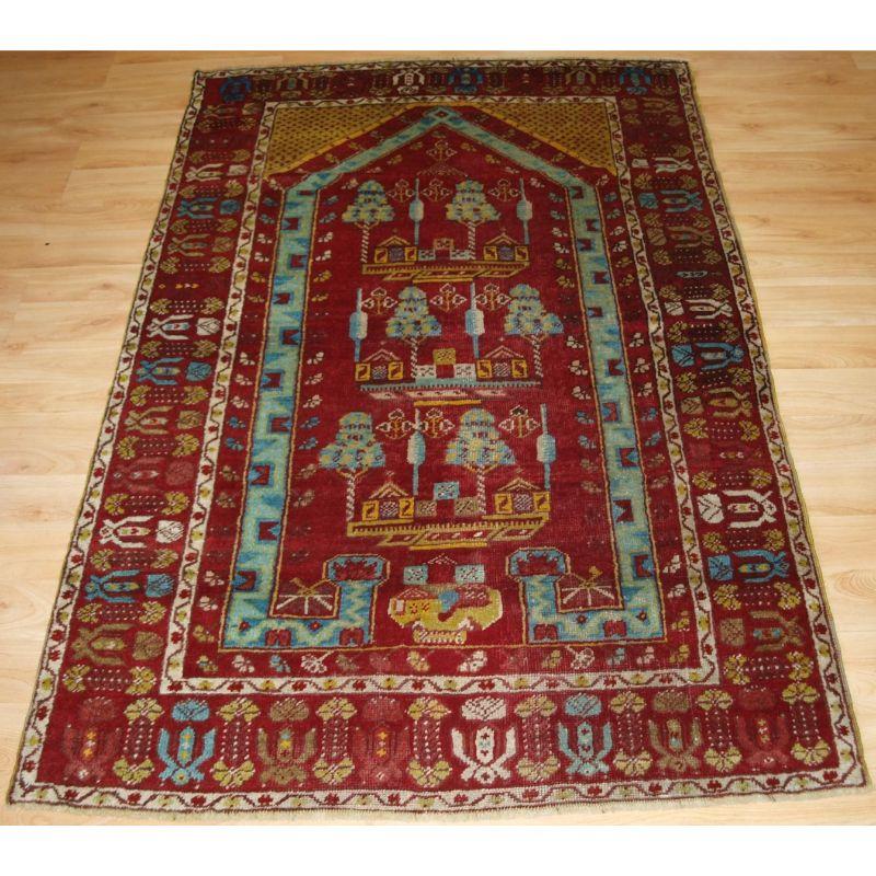 Antique Anatolian Kirsehir village prayer rug.

An interesting pictorial prayer rug with trees and villages houses. The rug is one of a pair that were woven at the same time.

A wide range of colours including soft blues, red and