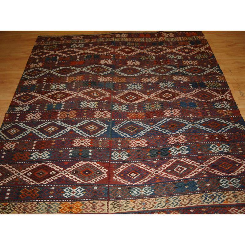Antique Anatolian Malatya kilim woven in two parts.

A good example of a Turkish Malatya region kilim with ci-cim embroidery to the surface. These kilims were woven on small looms in two narrow strips which were then stitched together. The kilim is