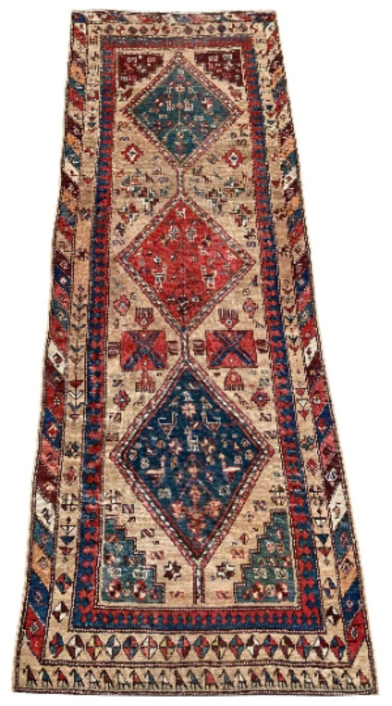 A beautiful antique runner, hand woven in eastern Turkey circa 1910 with a geometrical 3 medallion design on a soft camel colour. Lots of figures throughout including a chicken army at the bottom of the piece!
Size: 2.89m x 1.04m (9ft 6in x 3ft