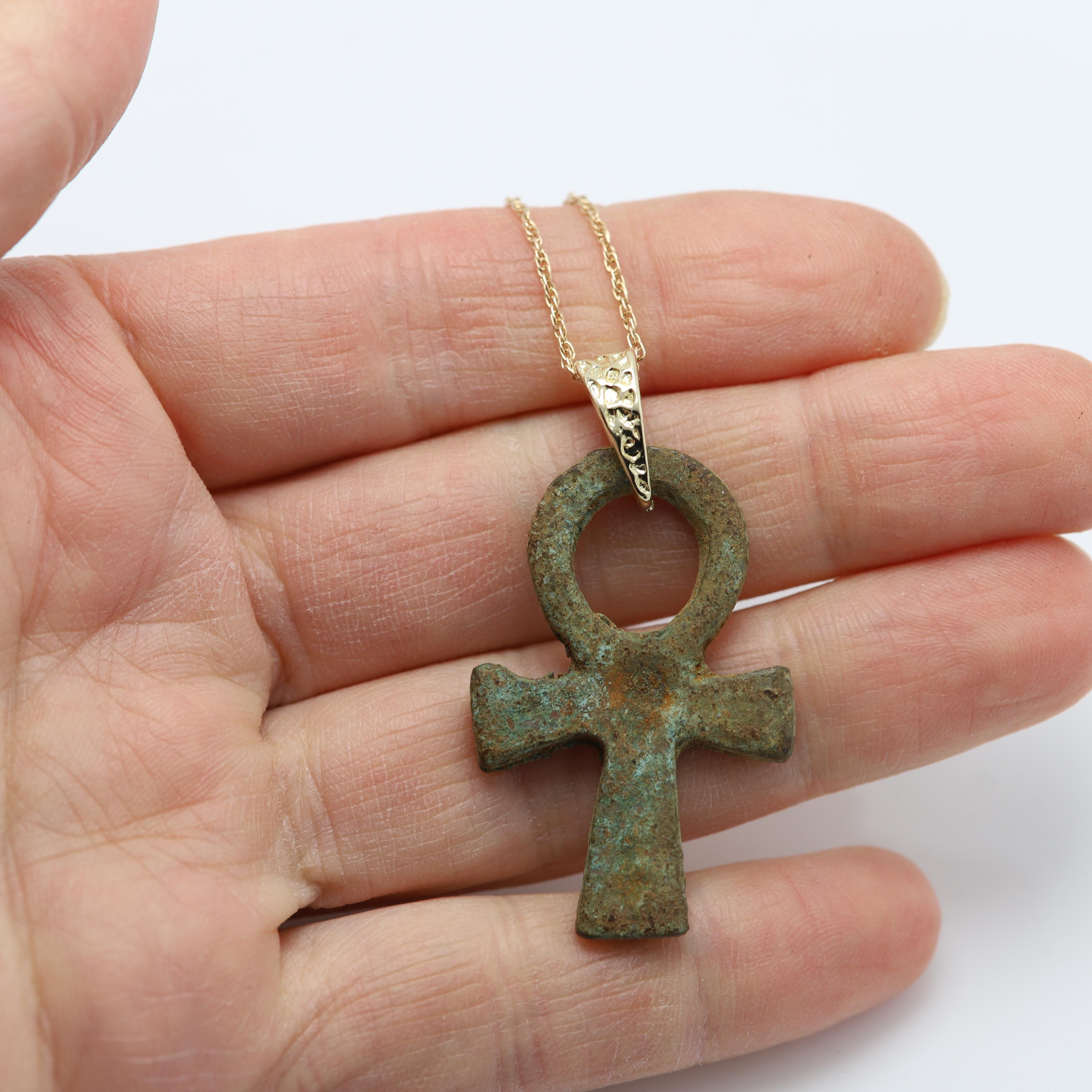 Ancient Authentic Bronze Ankh Pendant, the Egyptian symbol of life, with a rich green patina. 600BC
Approx size 1.75' inch (45 mm) 
14k Yellow Gold chain & bail.
Chain size: 18' inch.
The Onkh is an ancient Egyptian hieroglyphic symbol that was most