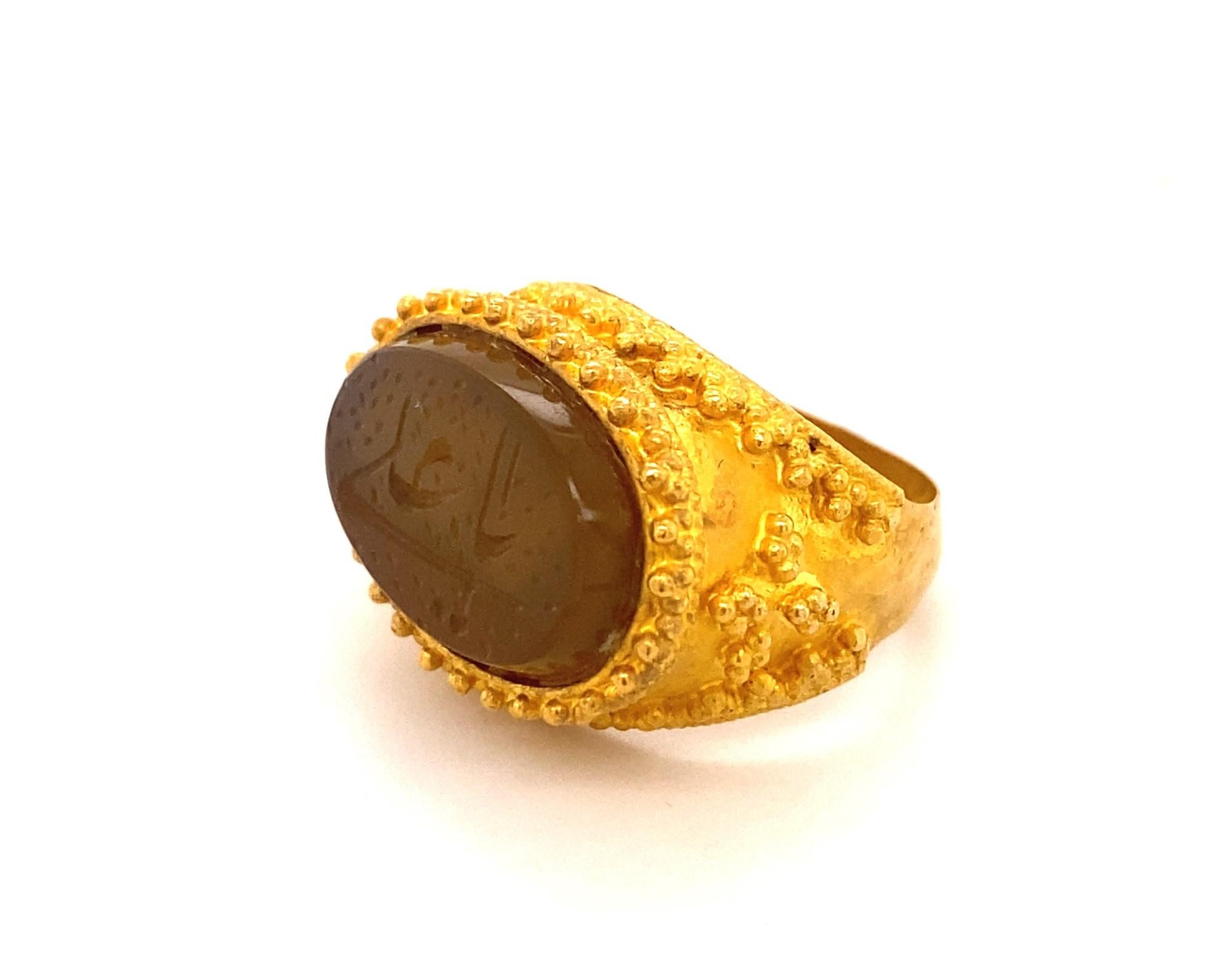 This is stunning antique ring made in high karat gold with crown like design. The agate portion has carved Arabic writing. The agate portion measures 18mm by 11mm. The ring has no hallmarks been tested for 22k gold possibly made in 24K. The setting