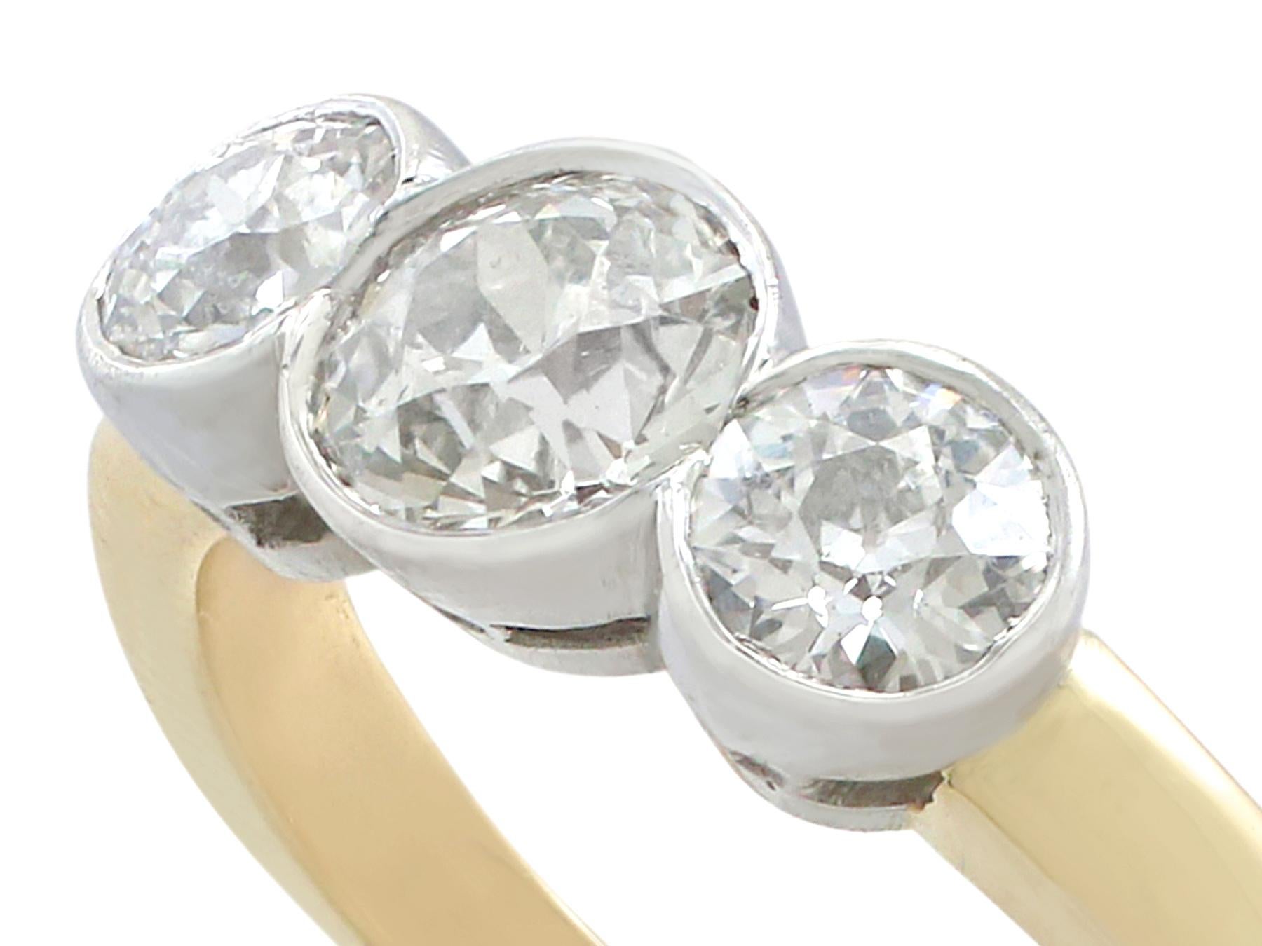 An impressive antique 1.69 Ct diamond and contemporary 18k yellow gold, 18k white gold set trilogy ring; part of our diverse antique jewelry collections.

This fine and impressive collet set diamond trilogy ring has been crafted in 18k yellow gold