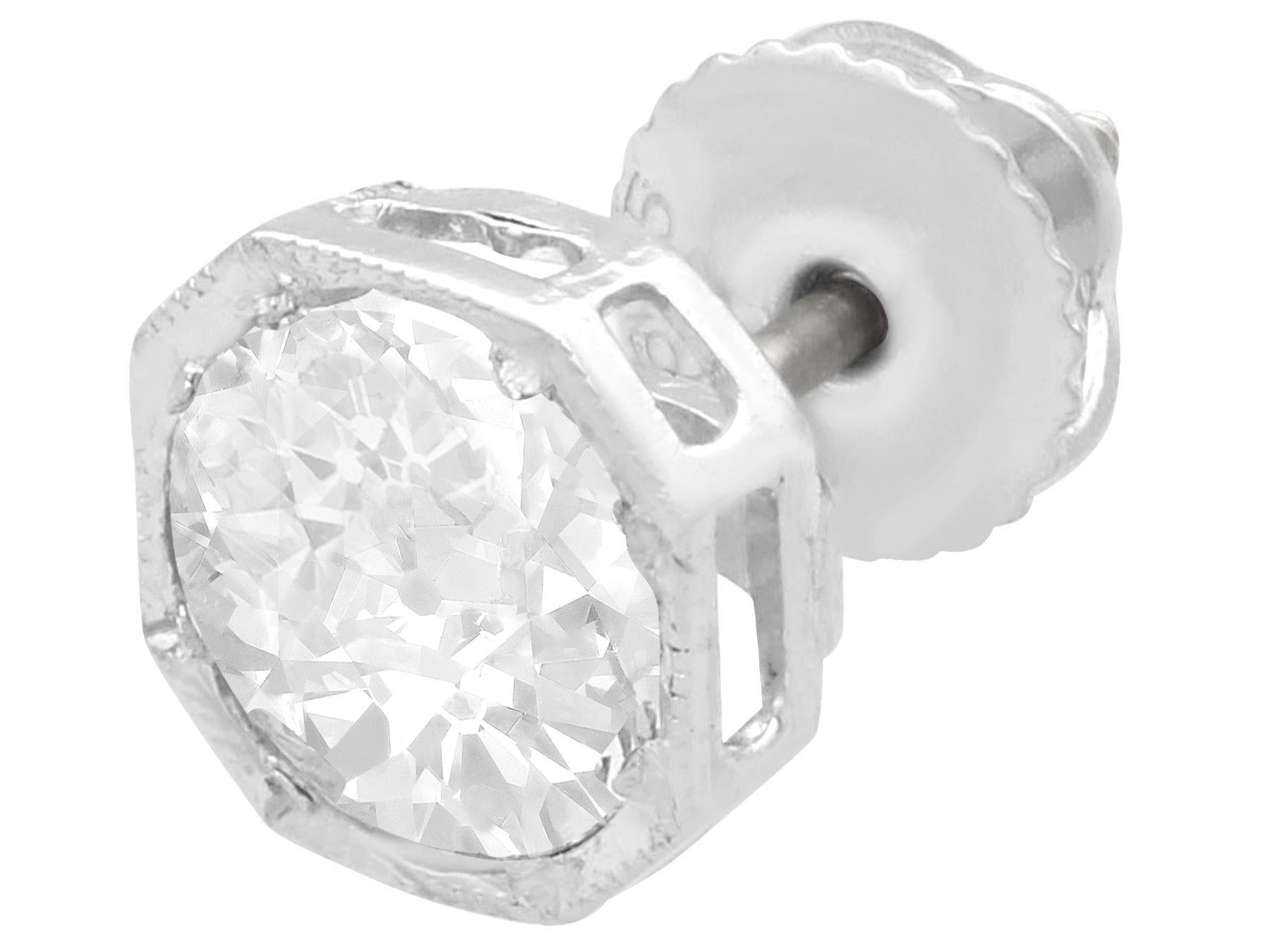 A stunning, fine and impressive pair of antique 2.02 carat diamond and contemporary platinum stud earrings; part of our diverse diamond jewelry and estate jewelry collections.

These stunning, fine and impressive diamond stud earrings with
