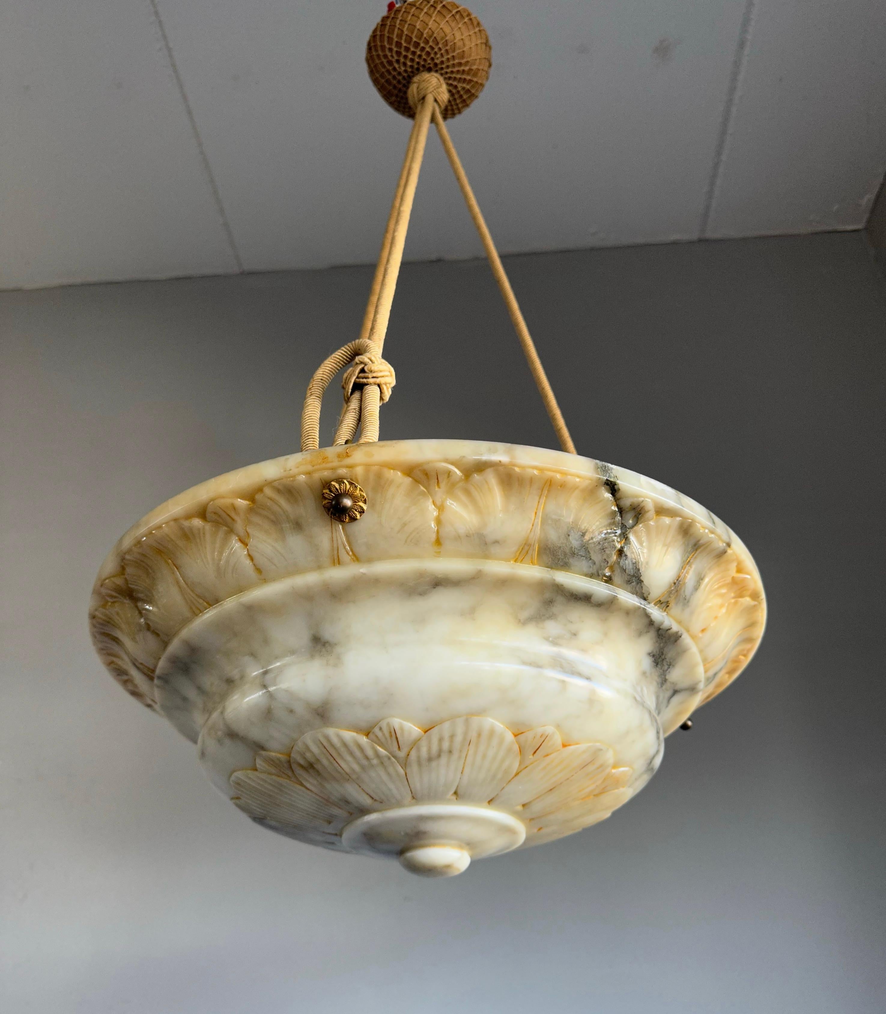 Top class chandelier with a unique white, black and amber color alabaster shade, perfect ropes and a hand knotted canopy.

Thank to its restored alabaster shade this antique chandelier is again in great condition and will light up both your days and